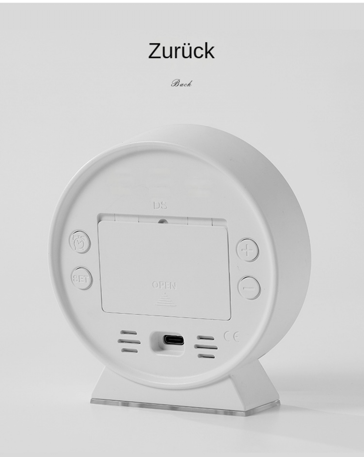 Rückseite einer weißen Uhr. Knöpfe, USB-Anschluss und Text 'OPEN' sichtbar. Oben steht 'Zurück' und 'Back'.