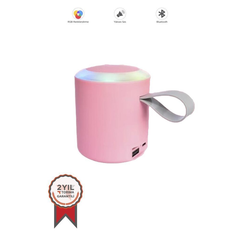 Tutacağı olan pembe bir hoparlör ve parlayan üst kısım. Üstte RGB, ses ve Bluetooth simgeleri var. Altta bir garanti mührü.