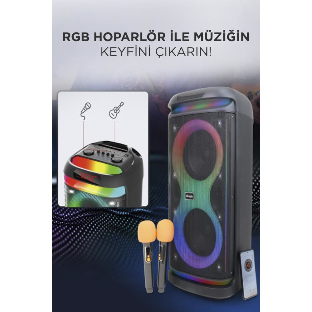 Renkli ışıklarla büyük siyah bir hoparlör. Önünde iki mikrofon ve bir kontrol paneli var. Sağda bir telefon var.
