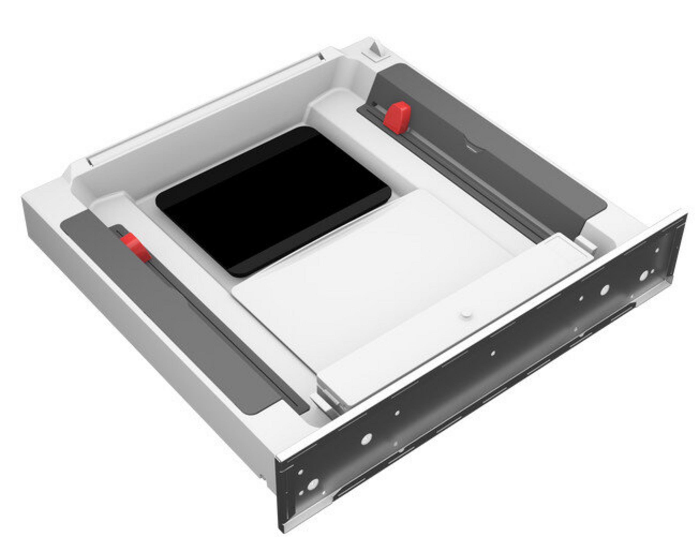 Otwarta szuflada z czarno-białymi elementami. Ma czerwone akcenty i ciemnoszarą górę.