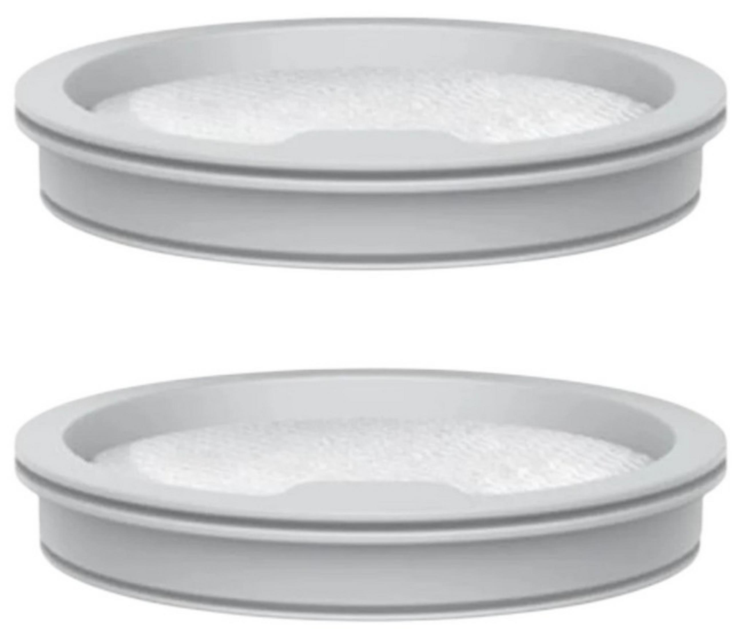 Deux objets circulaires gris identiques avec des intérieurs blancs et texturés, peut-être des filtres ou des récipients.