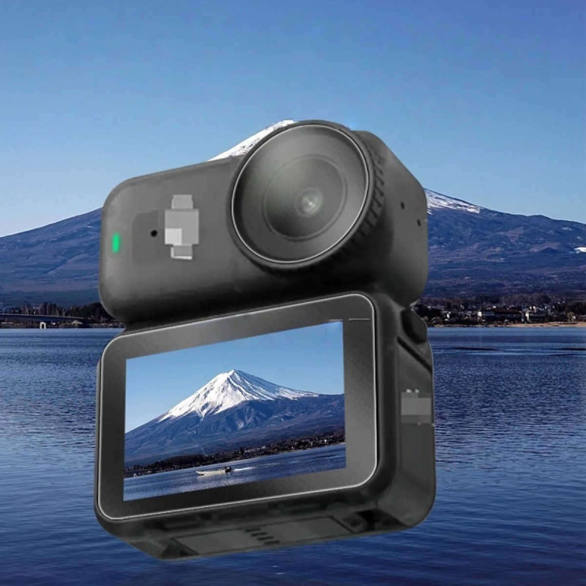 Czarny aparat wyświetla scenę górską, odzwierciedlając tło. Góra ma ośnieżony szczyt na tle błękitnego nieba.