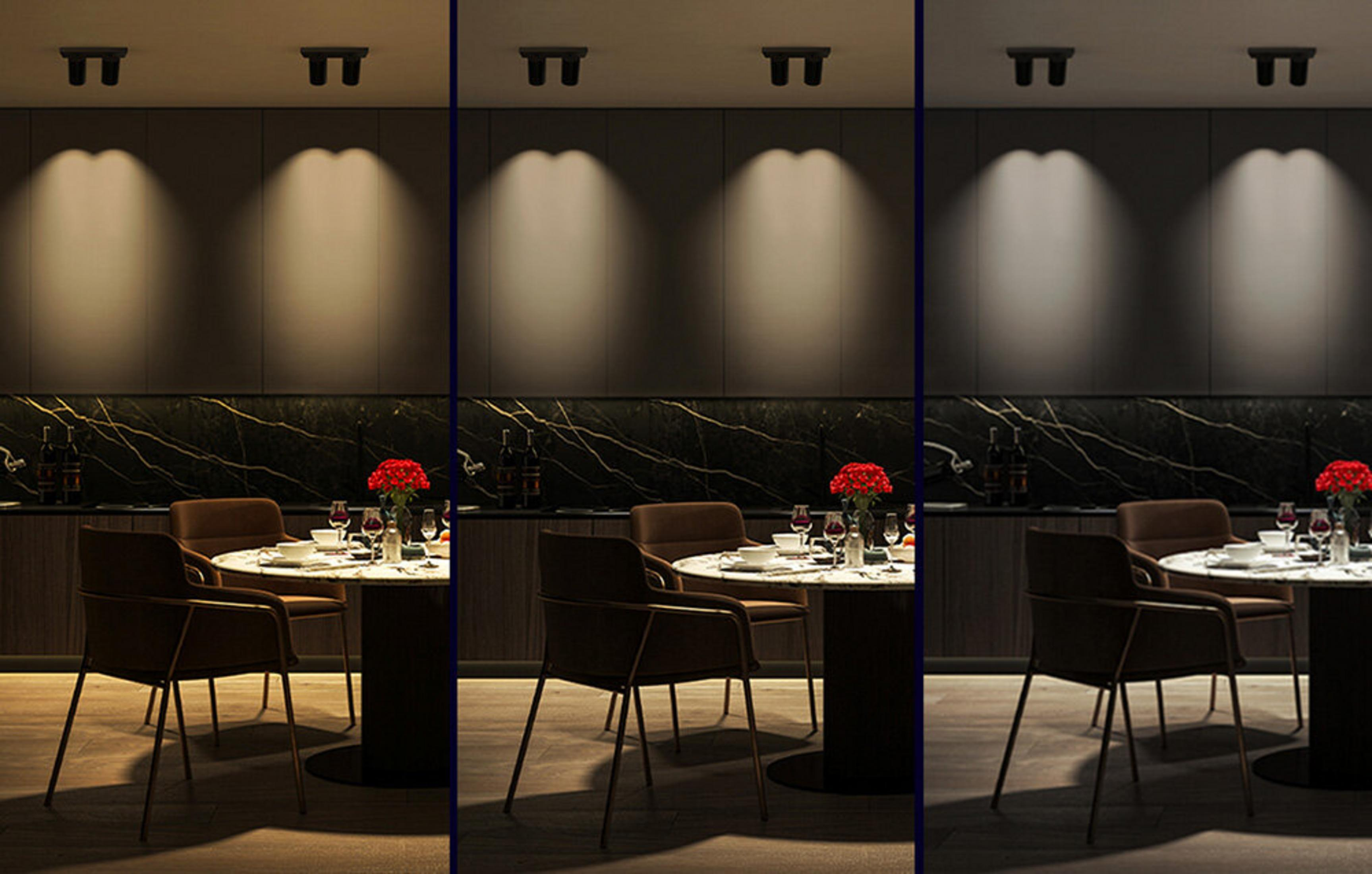 Scena w jadalni ze stołem nakrytym do posiłku, krzesłami, oświetleniem sufitowym i ciemnym blatem marmurowym.