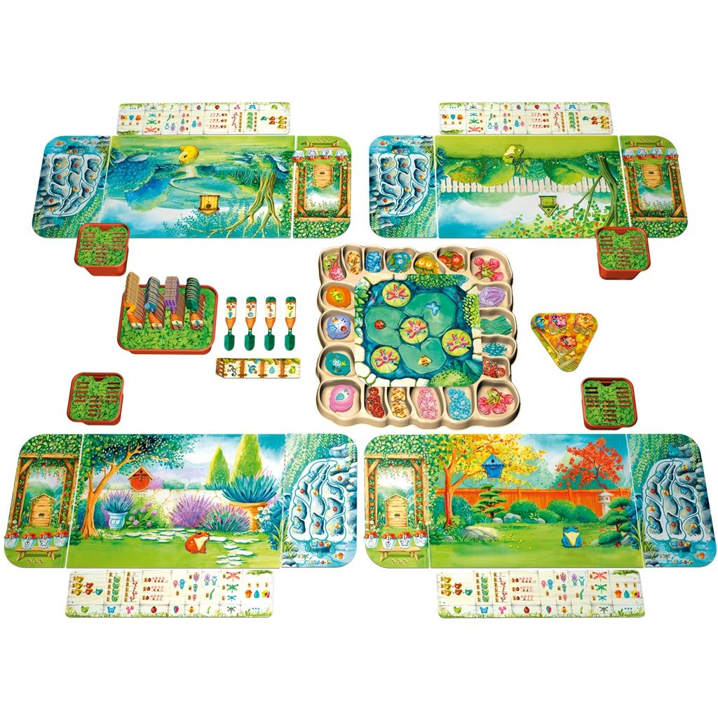 Un juego de mesa colorido con elementos de jardín y estanque. Incluye cartas, fichas y un tablero central de juego de estanque.