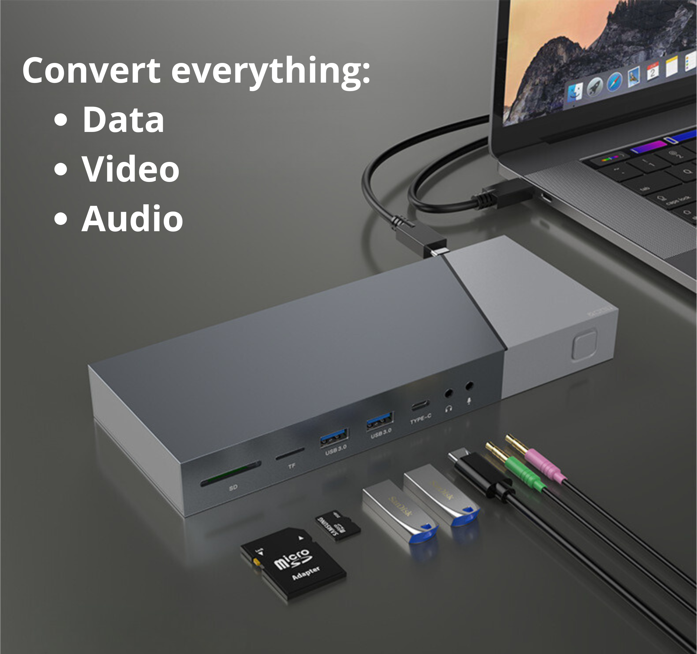 A laptop connected to a docking station. SD card, USB drives, and audio cables are present. Text: Convert everything: Data, Video, Audio.