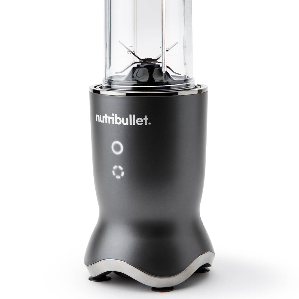 A gray Nutribullet blender on white. It has a clear container with blades, a gray base, and a silver trim.