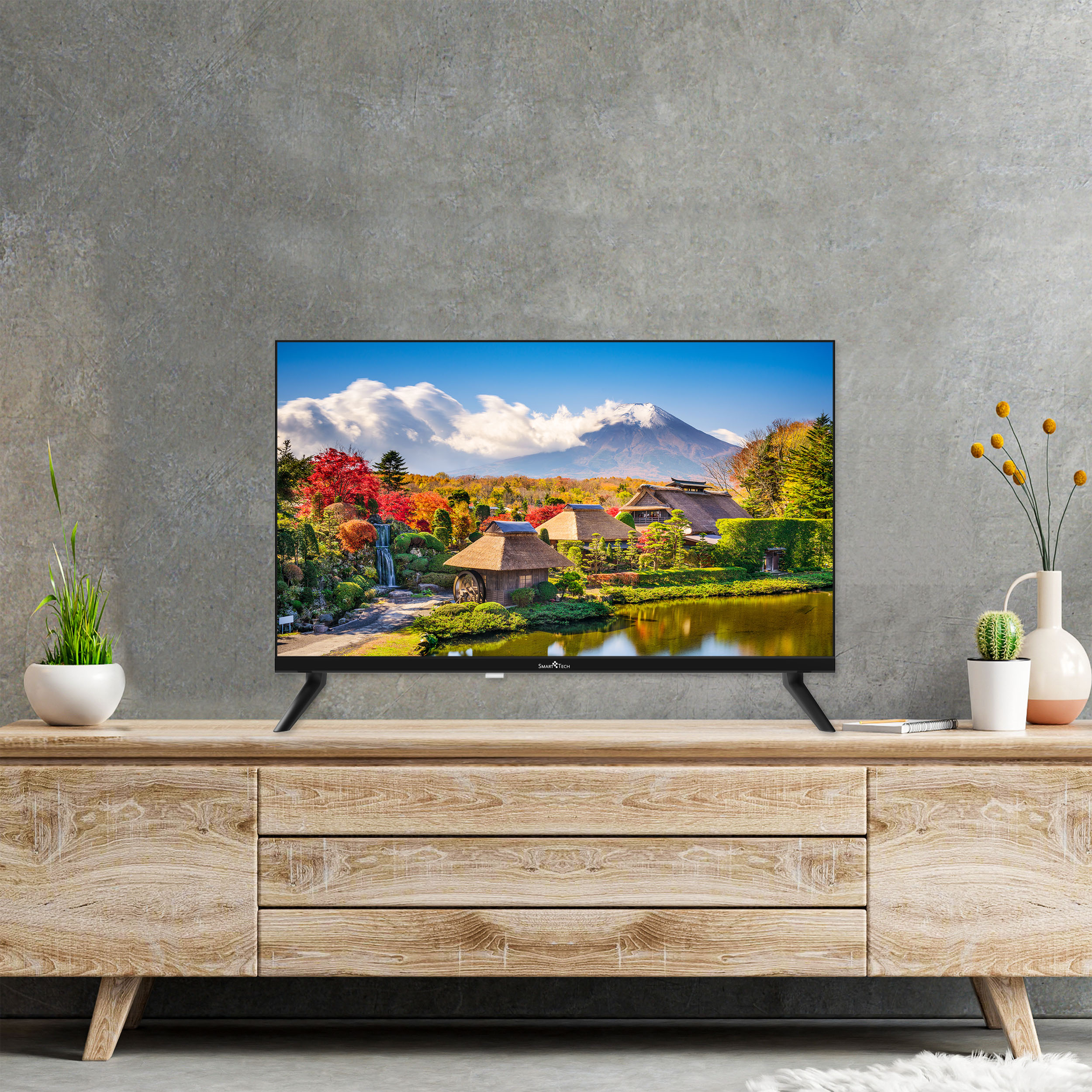 TV su mobile in legno, mostra un paesaggio montano con lago e case giapponesi tradizionali.
