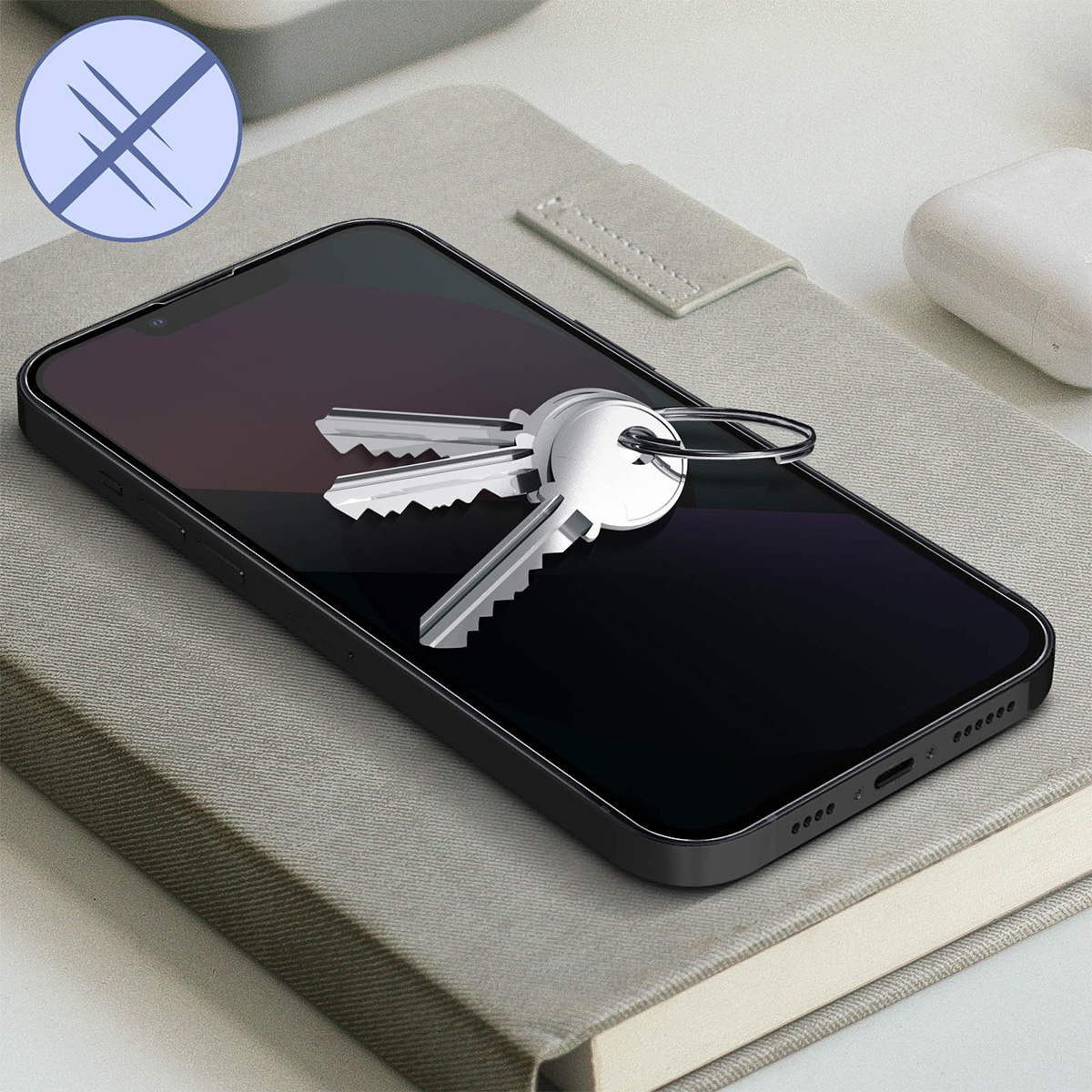 Un smartphone avec des clés dessus, posé sur un cahier. Le téléphone a un écran noir. Une icône rayée en arrière-plan.