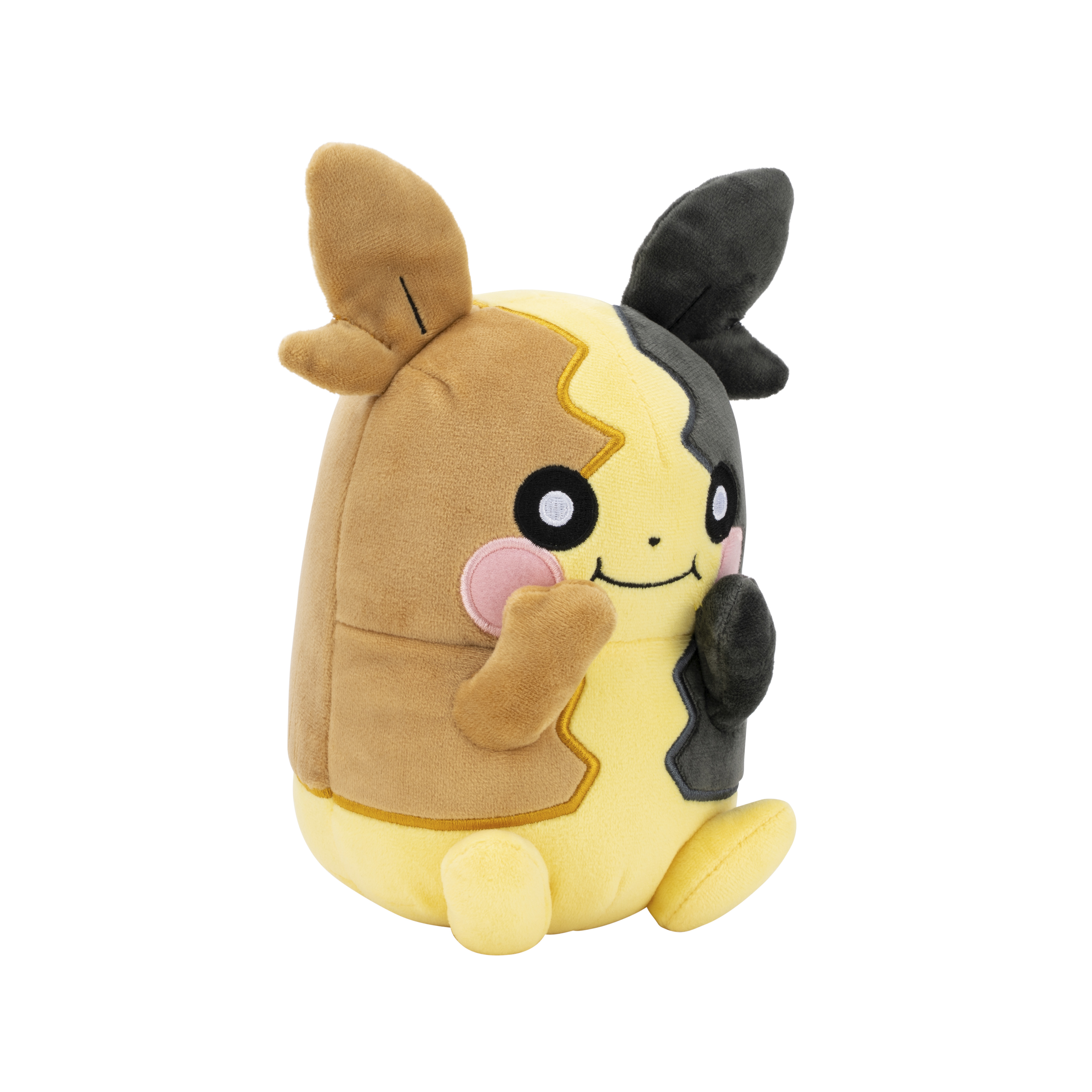 Un personnage en peluche marron et jaune avec des oreilles et des yeux noirs assis.