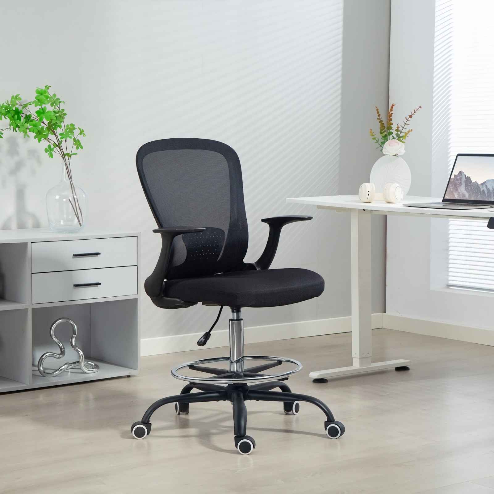 Schwarzer Netz-Bürostuhl mit Chromakzenten in einem modernen Büro.