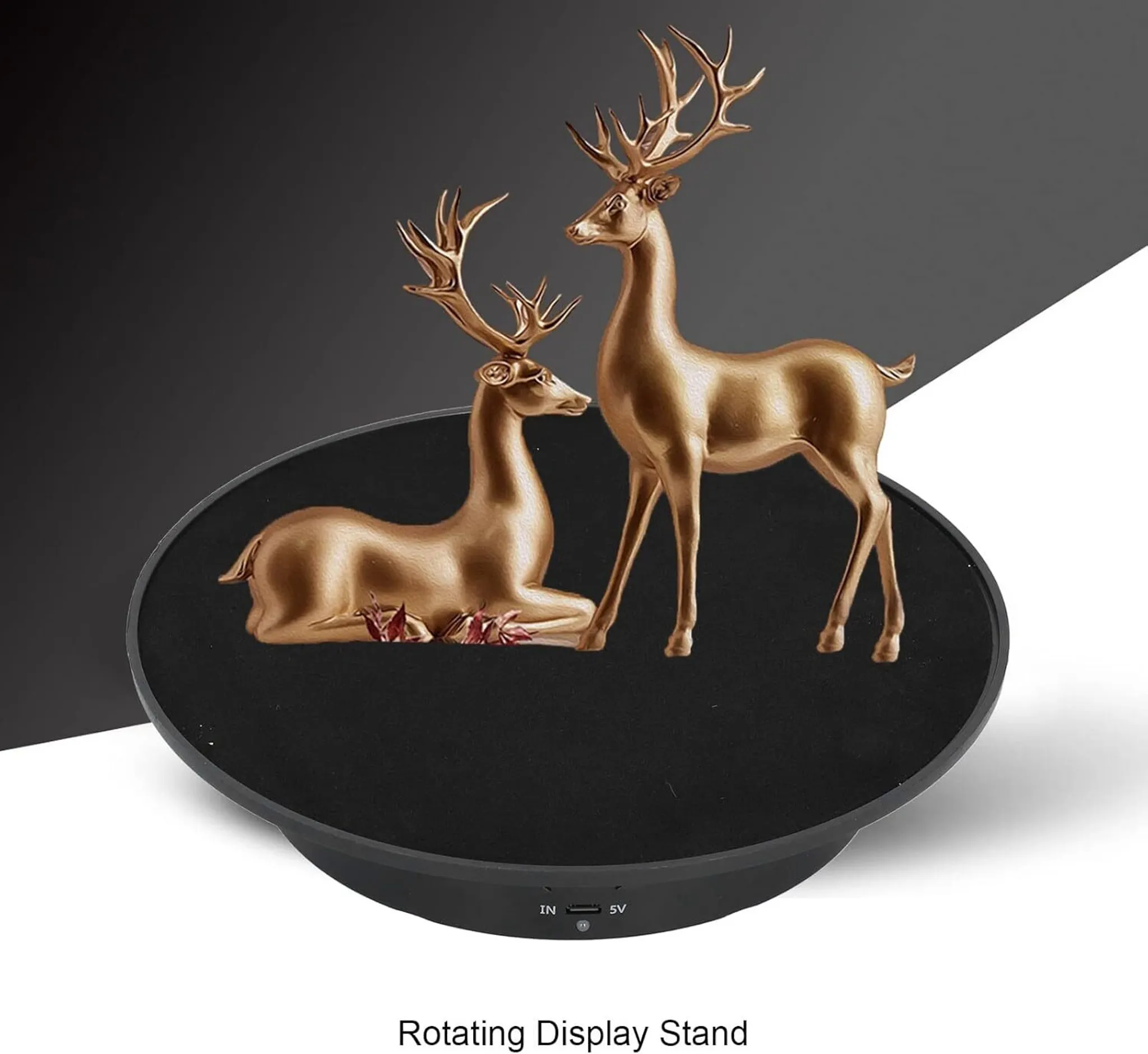 Zwei goldene Hirschfiguren auf einem schwarzen, drehenden Display-Ständer.