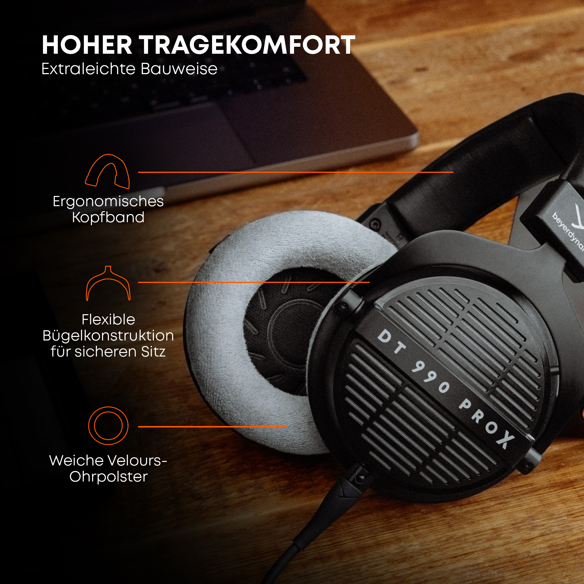 Schwarze DT 990 PROX Kopfhörer mit grauen Ohrpolstern auf einem Holztisch. Merkmale hervorgehoben.