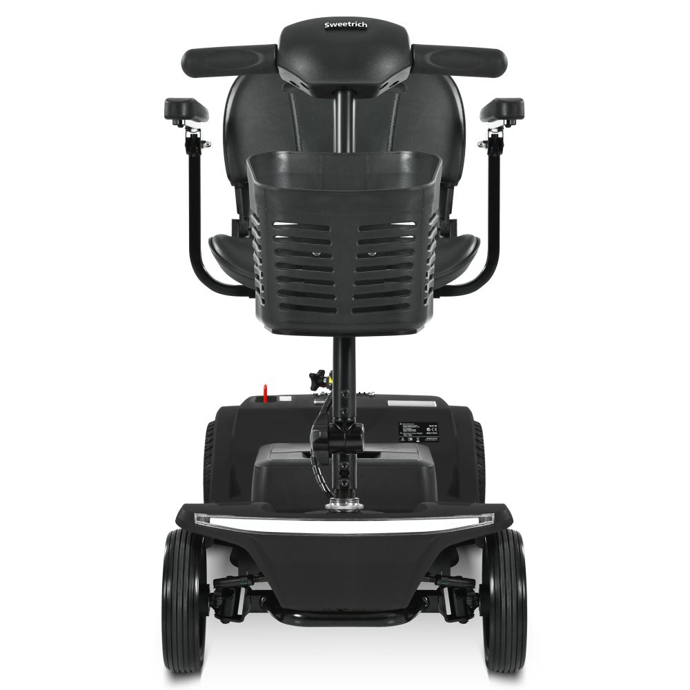 Un scooter de movilidad negro con una cesta delante del asiento y dos ruedas delanteras.