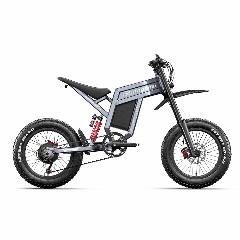Una bicicleta eléctrica de montaña gris con neumáticos anchos y amortiguador trasero.