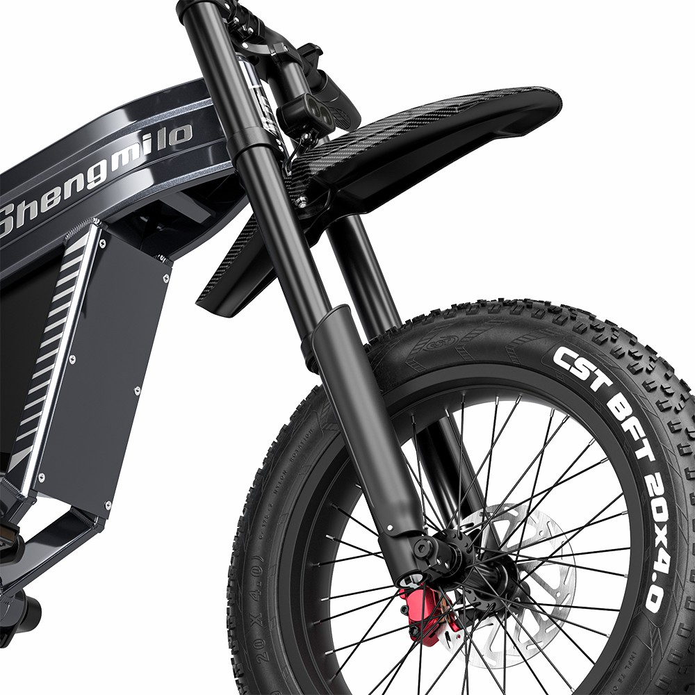 Rueda delantera, manillar y parte del cuadro de una bicicleta eléctrica negra. Texto blanco en neumático.