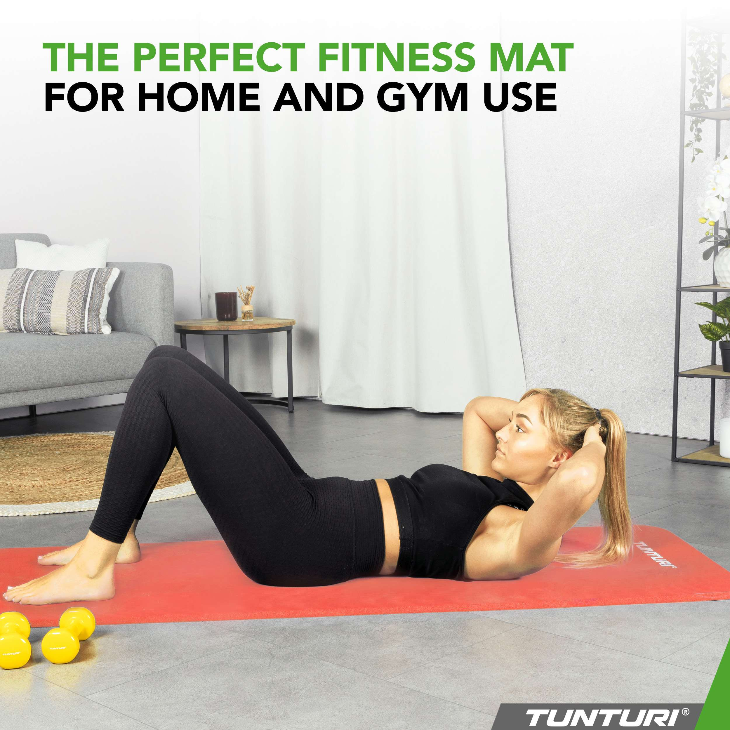 A woman exercises on a red mat with dumbbells.