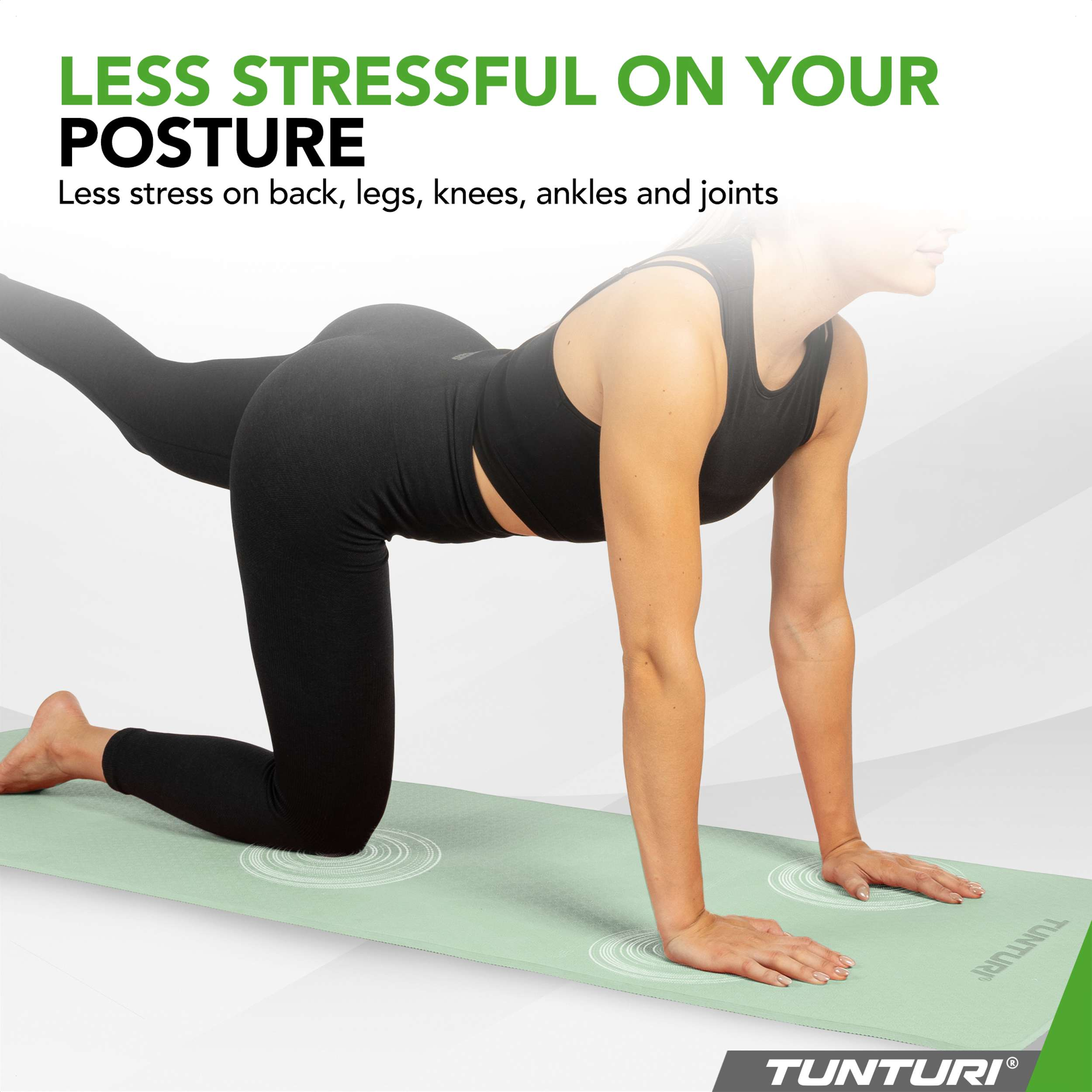 A woman in black activewear performs a yoga pose on a light green mat.