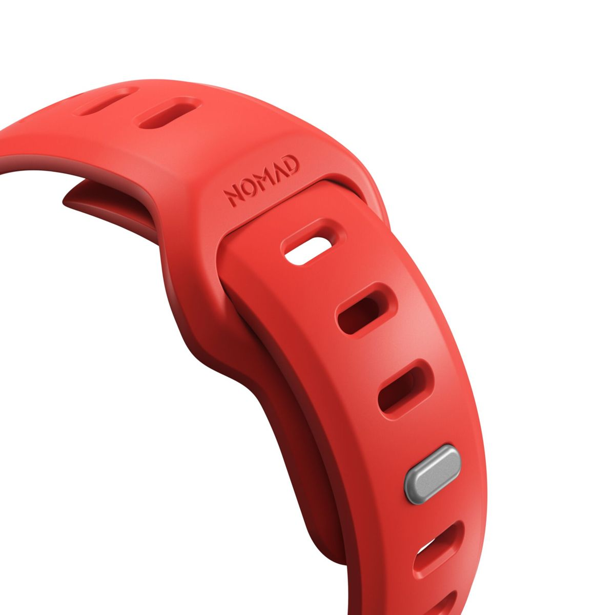 Primer plano de una correa de reloj Nomad roja con agujeros ajustables y un cierre plateado.