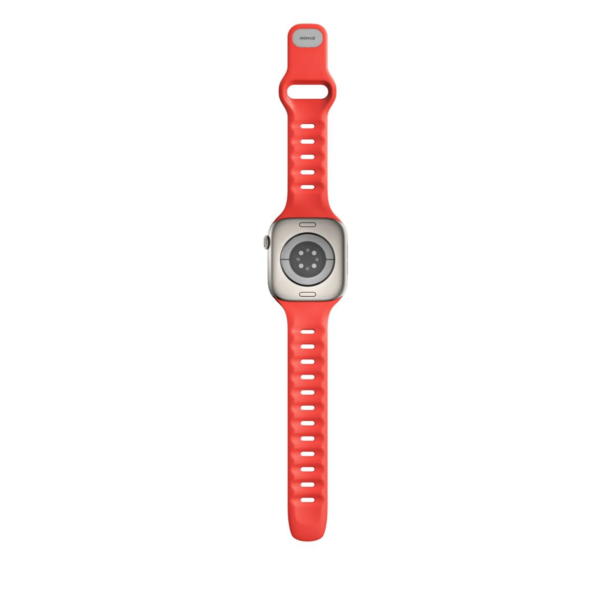 Reloj inteligente rojo con carcasa plateada, mostrado boca abajo. Los contactos de carga son visibles en la parte posterior.