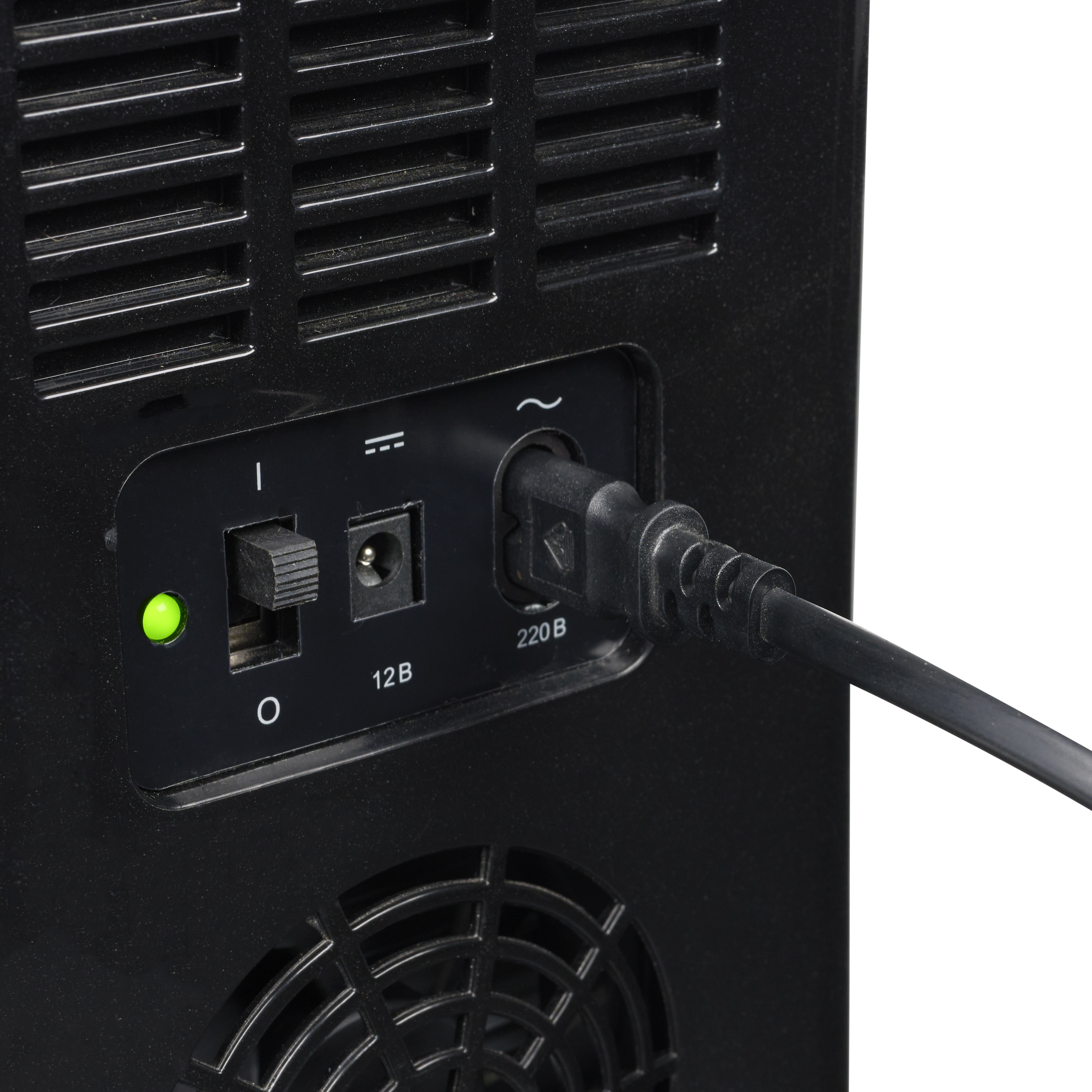 A power plug is inserted into a black socket. A green light is illuminated.