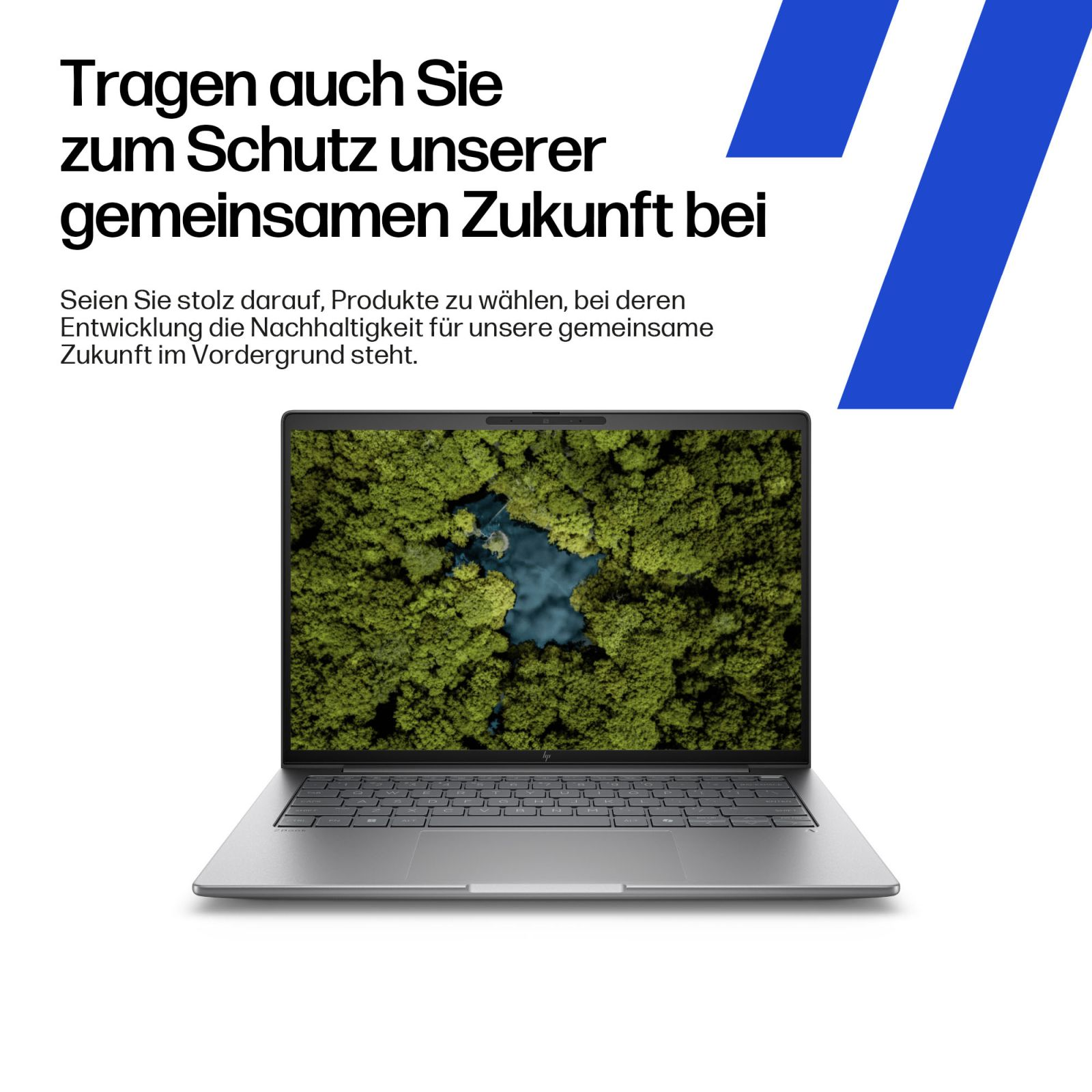 Laptop wyświetla bujny zielony las z błękitnym jeziorem z lotu ptaka.