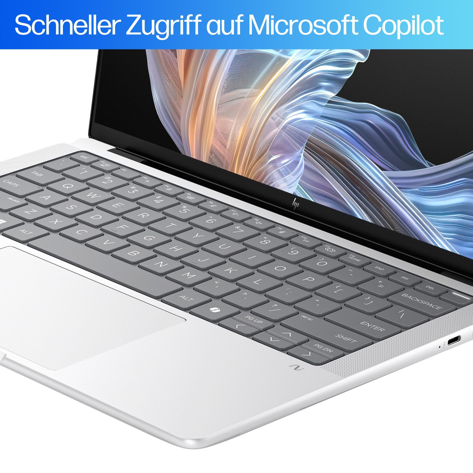 Laptop z klawiaturą i ekranem wyświetlającym grafikę abstrakcyjną. Tekst: 'Schneller Zugriff auf Microsoft Copilot'.