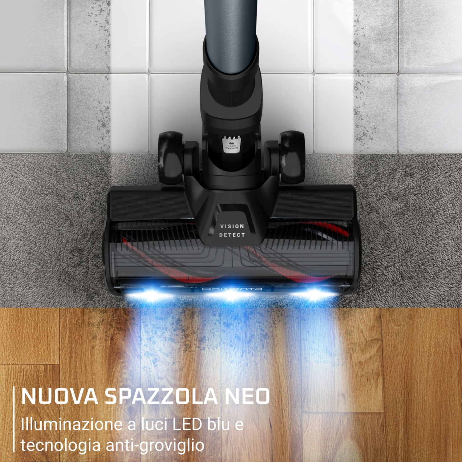Cepillo de aspiradora negro con luces LED azules sobre madera y alfombra.