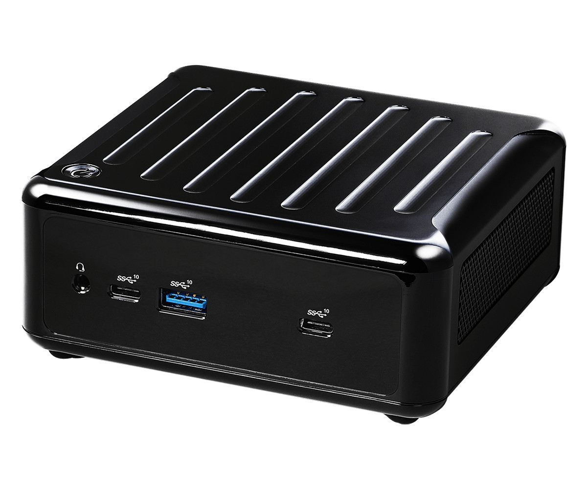 Un mini PC nero con parte superiore a coste, porte USB anteriori e jack per cuffie.