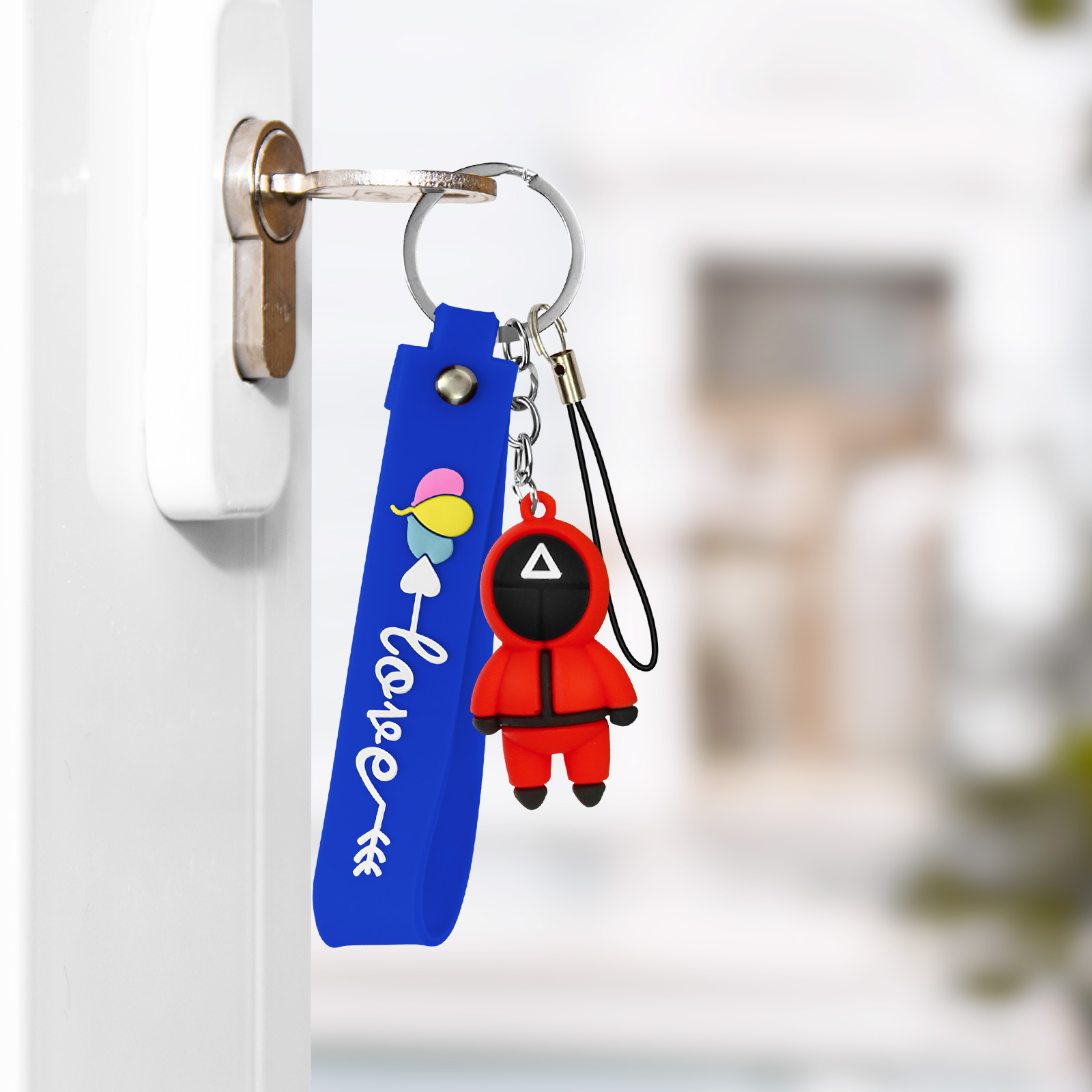 Un portachiavi con una figura rossa e un cinturino blu con scritta "love".