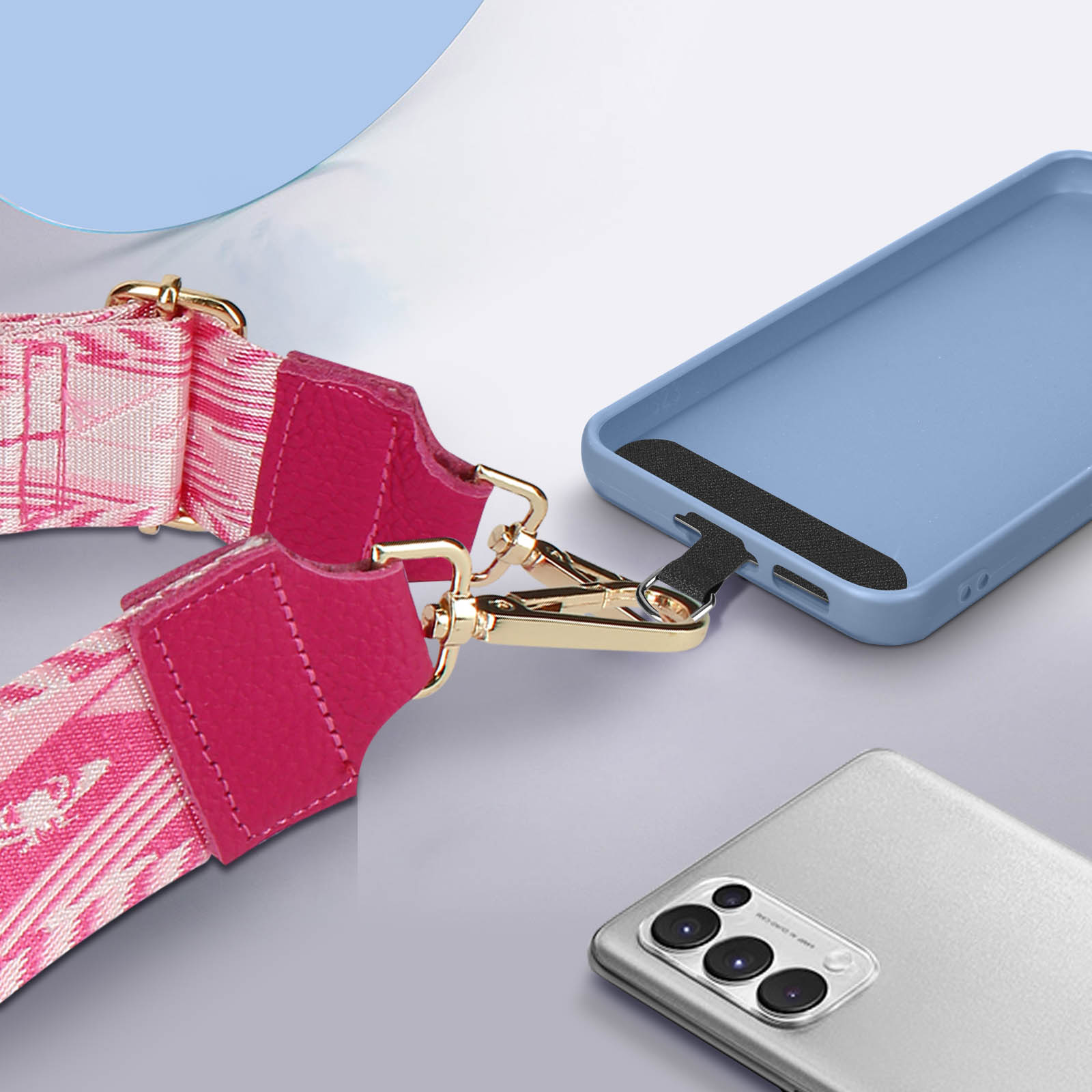 Una custodia blu per telefono è attaccata a una cinghia rosa, con un altro telefono accanto.