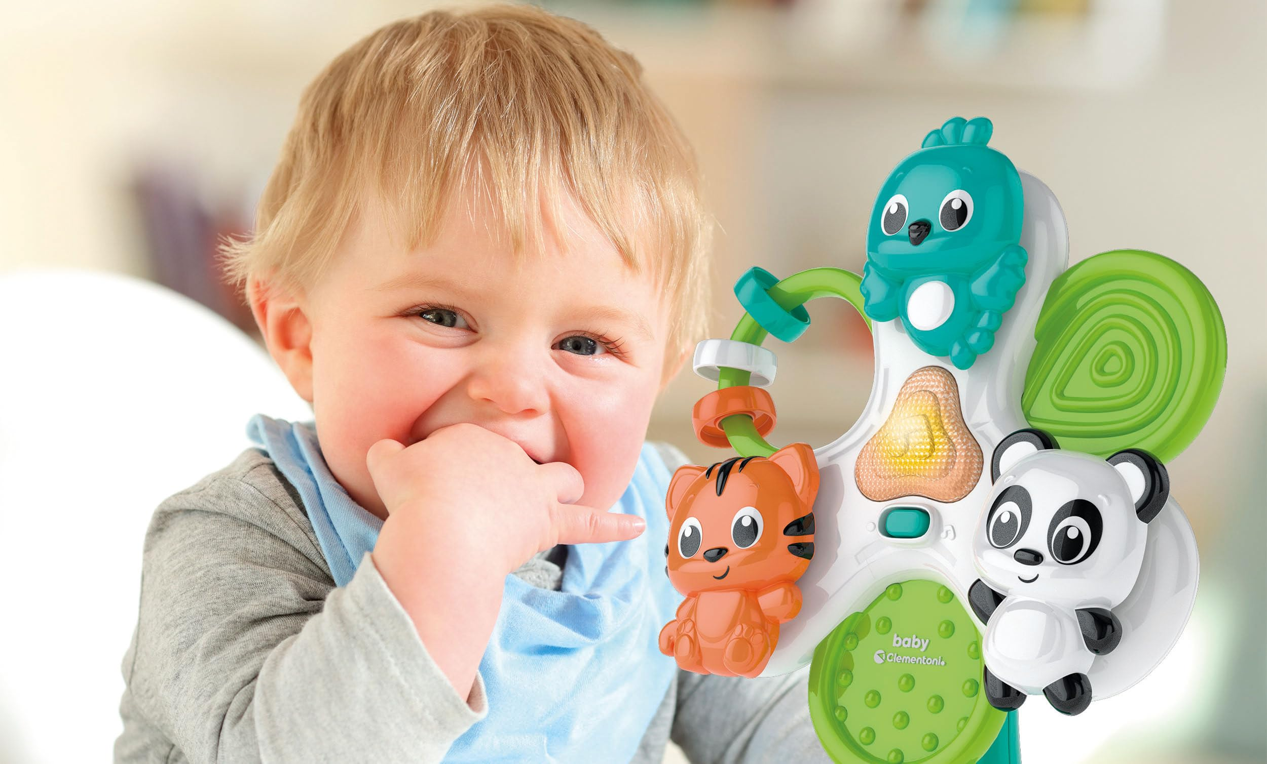 Un bambino biondo gioca con un giocattolo colorato con personaggi animali.