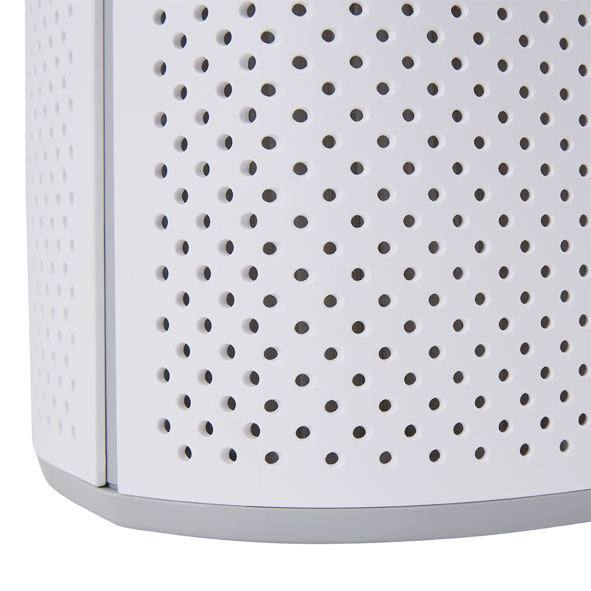 Close up of a white perforated surface with a gray base. Clean, modern design.