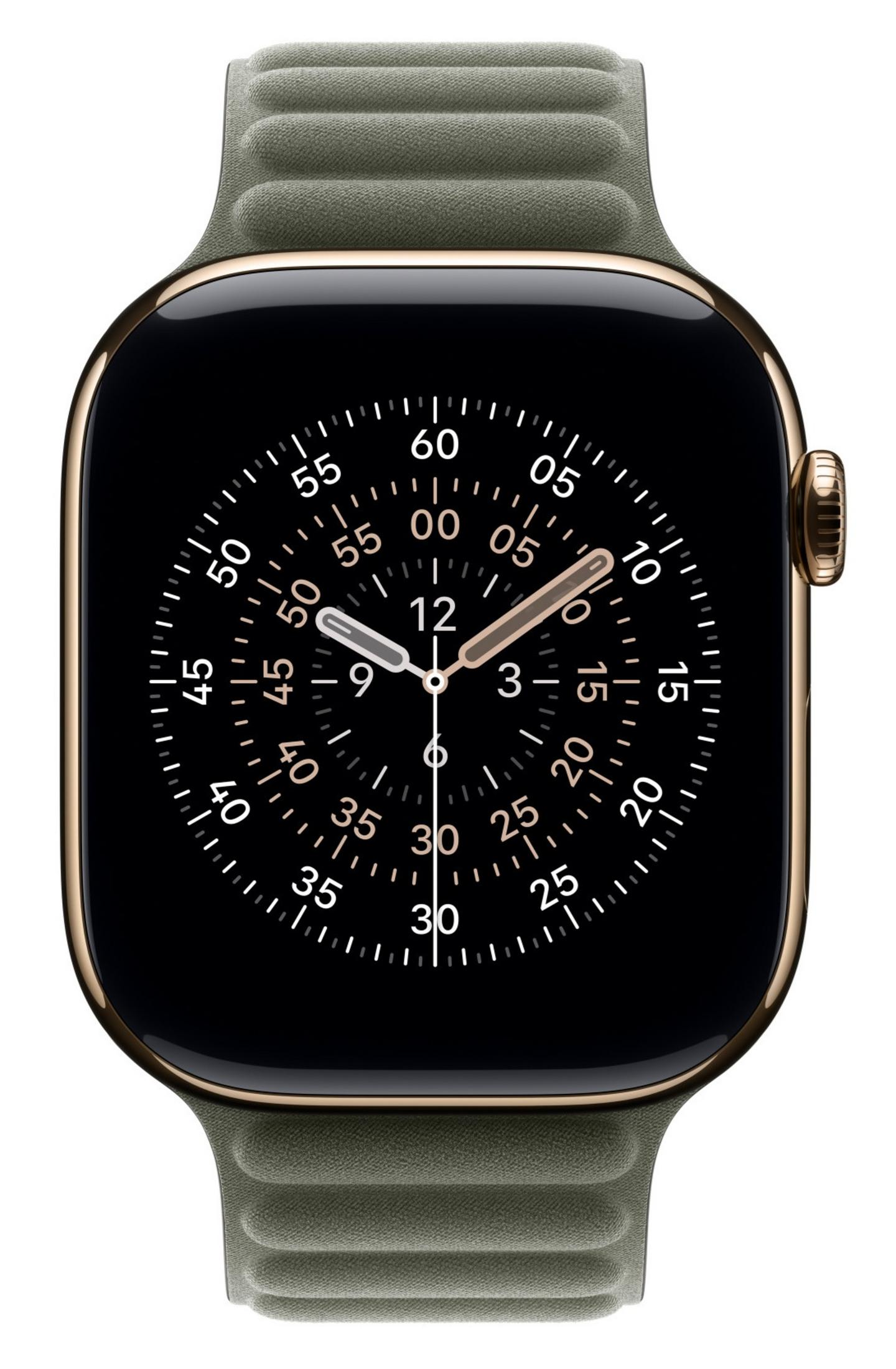 Apple Watch dorada con correa verde y pantalla negra con esfera de reloj analógica.