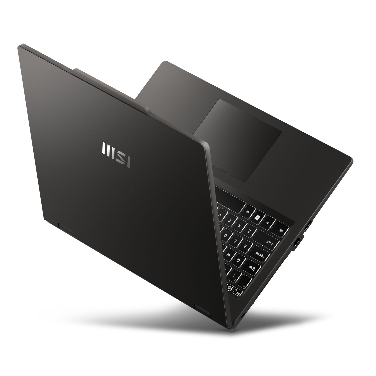 Ciemnoszary laptop MSI jest otwarty, z podświetlaną klawiaturą i gładzikiem.