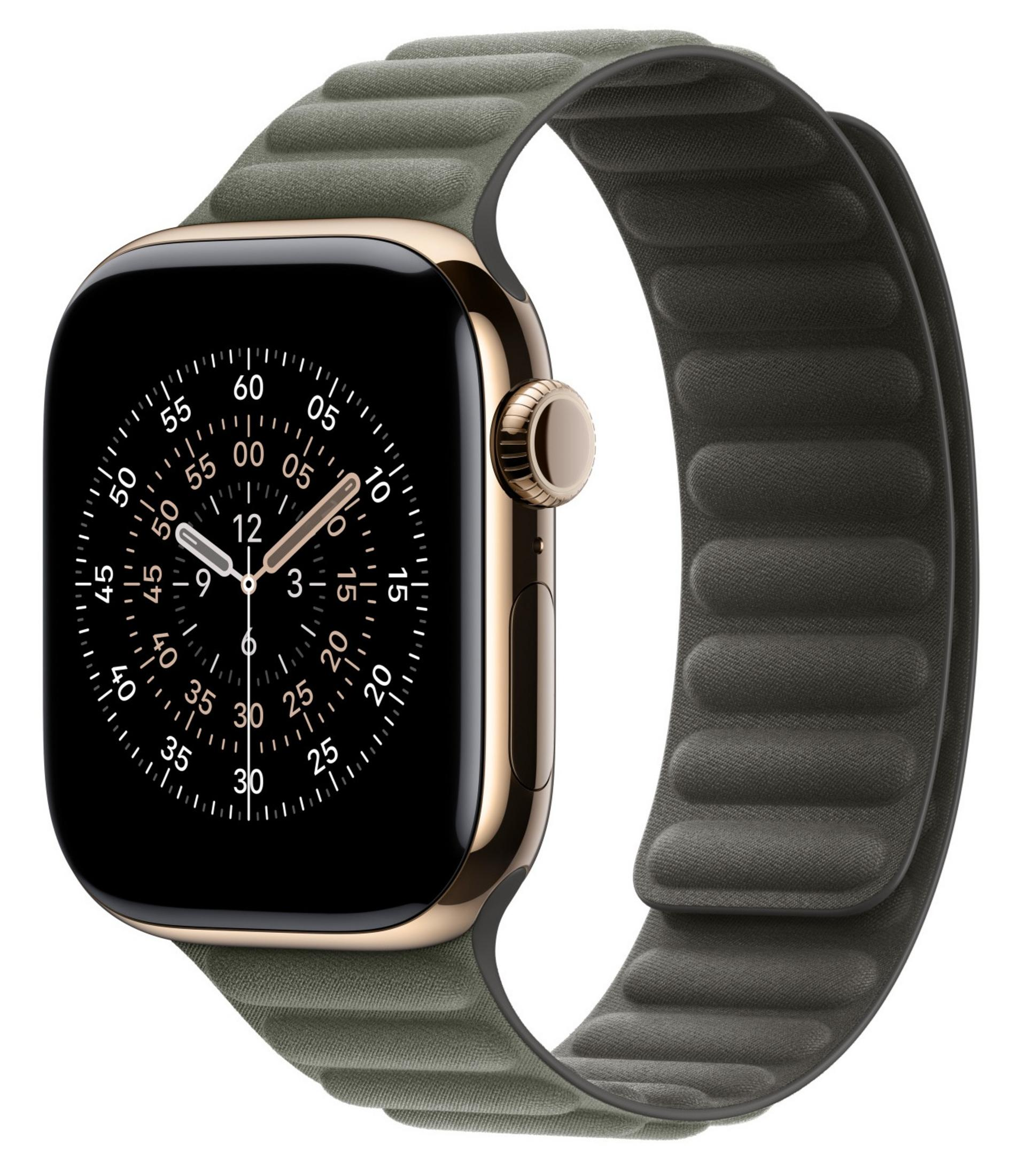Un Apple Watch dorato con cinturino verde mostra un quadrante nero con segni dell'ora bianchi.