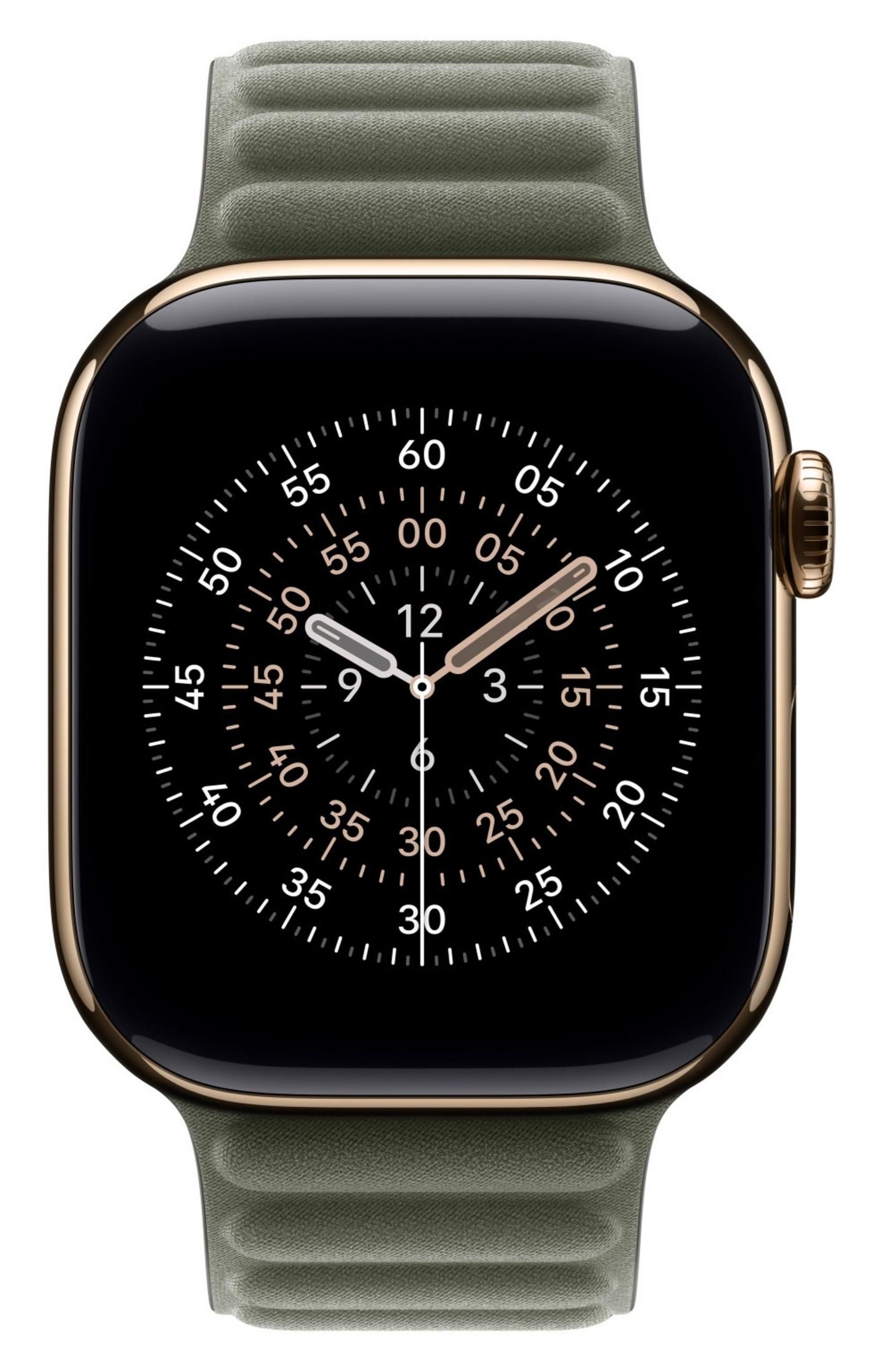 Un Apple Watch dorato con cinturino verde mostra uno schermo nero con quadrante analogico bianco.