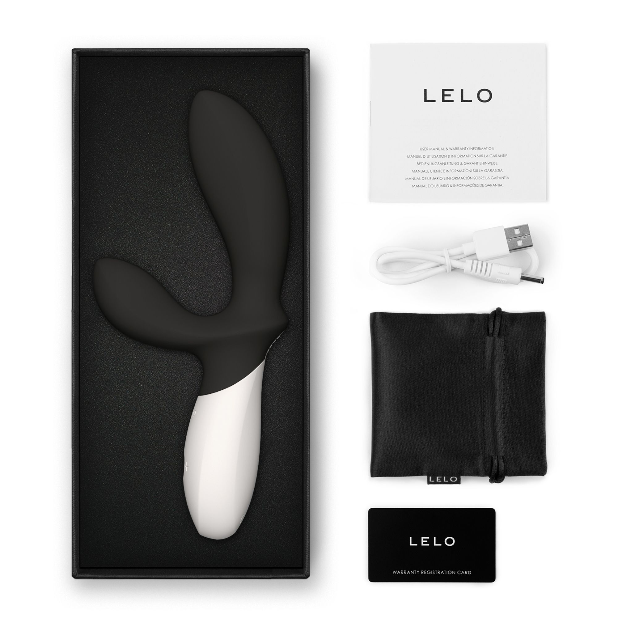 Un vibrador en blanco y negro en una caja, con manual, cable de carga, bolsa y tarjeta de garantía.