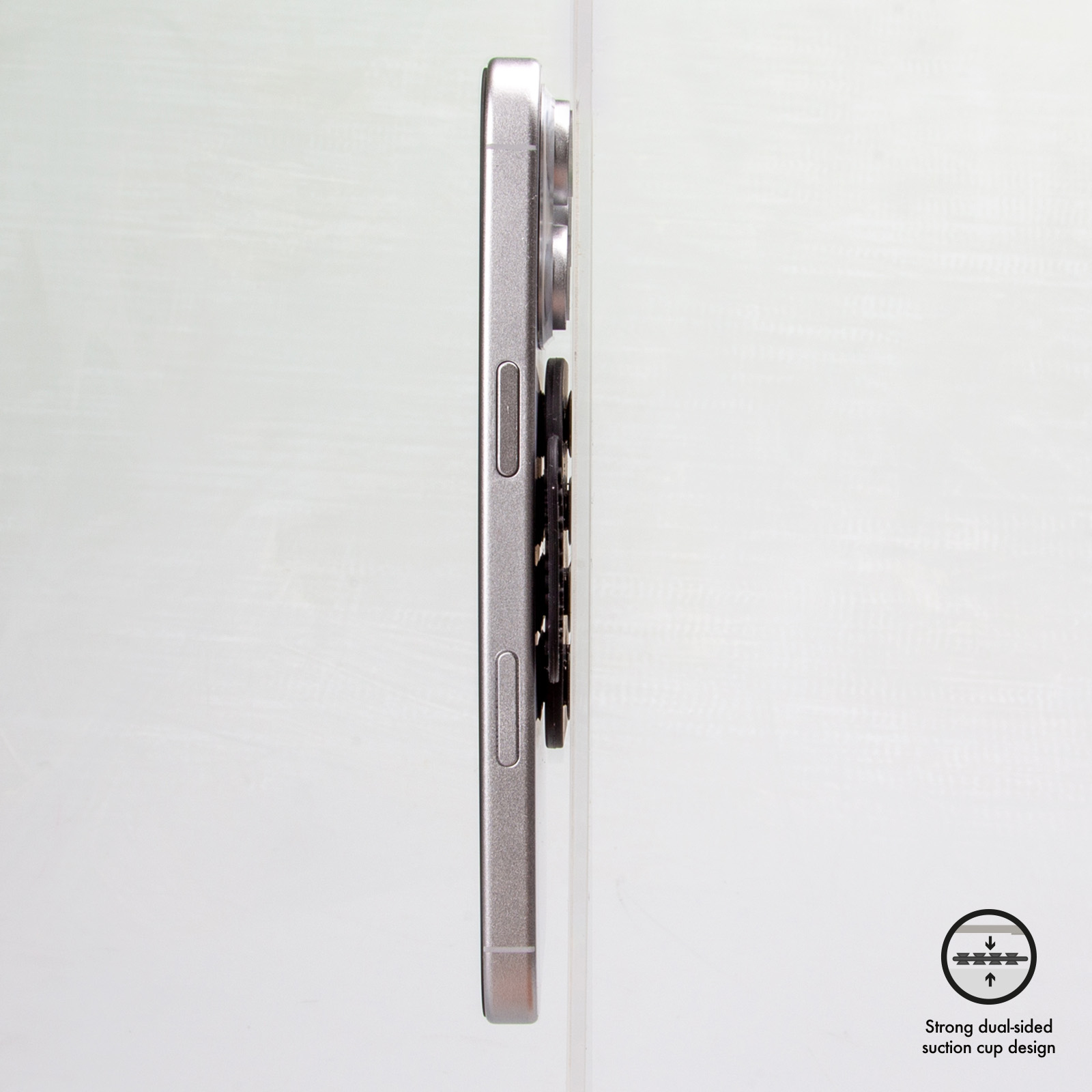 Smartphone argentato con accessorio nero di lato su sfondo chiaro.