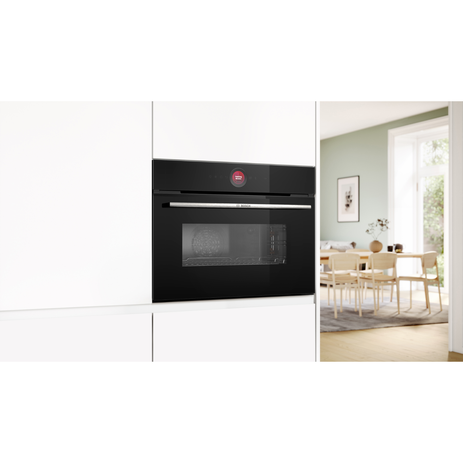 Un moderno forno nero Bosch è integrato in mobili bianchi, con una zona pranzo sullo sfondo.