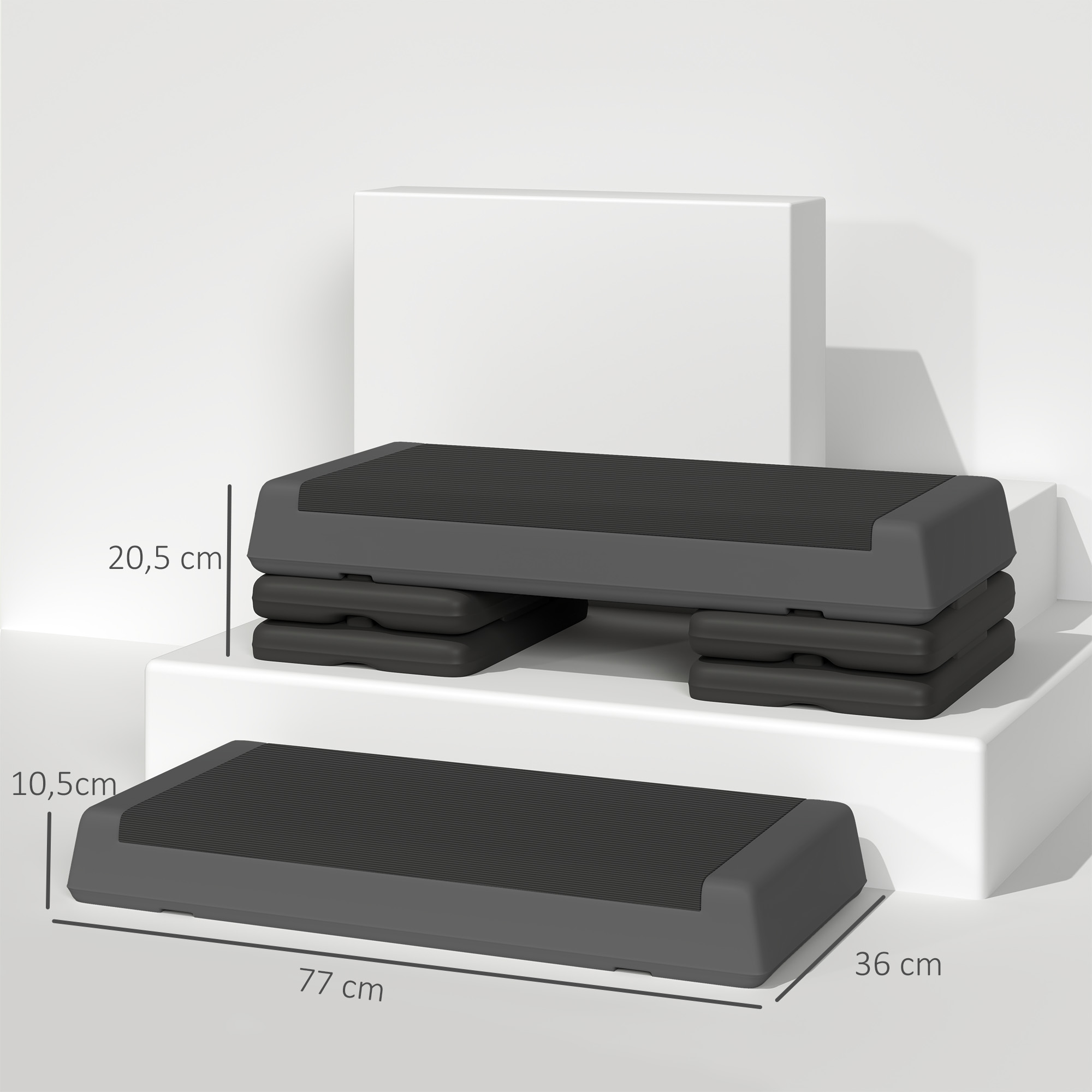 Dos plataformas de step aeróbico grises sobre bloques blancos. Una es más pequeña, otra más grande y apilada.