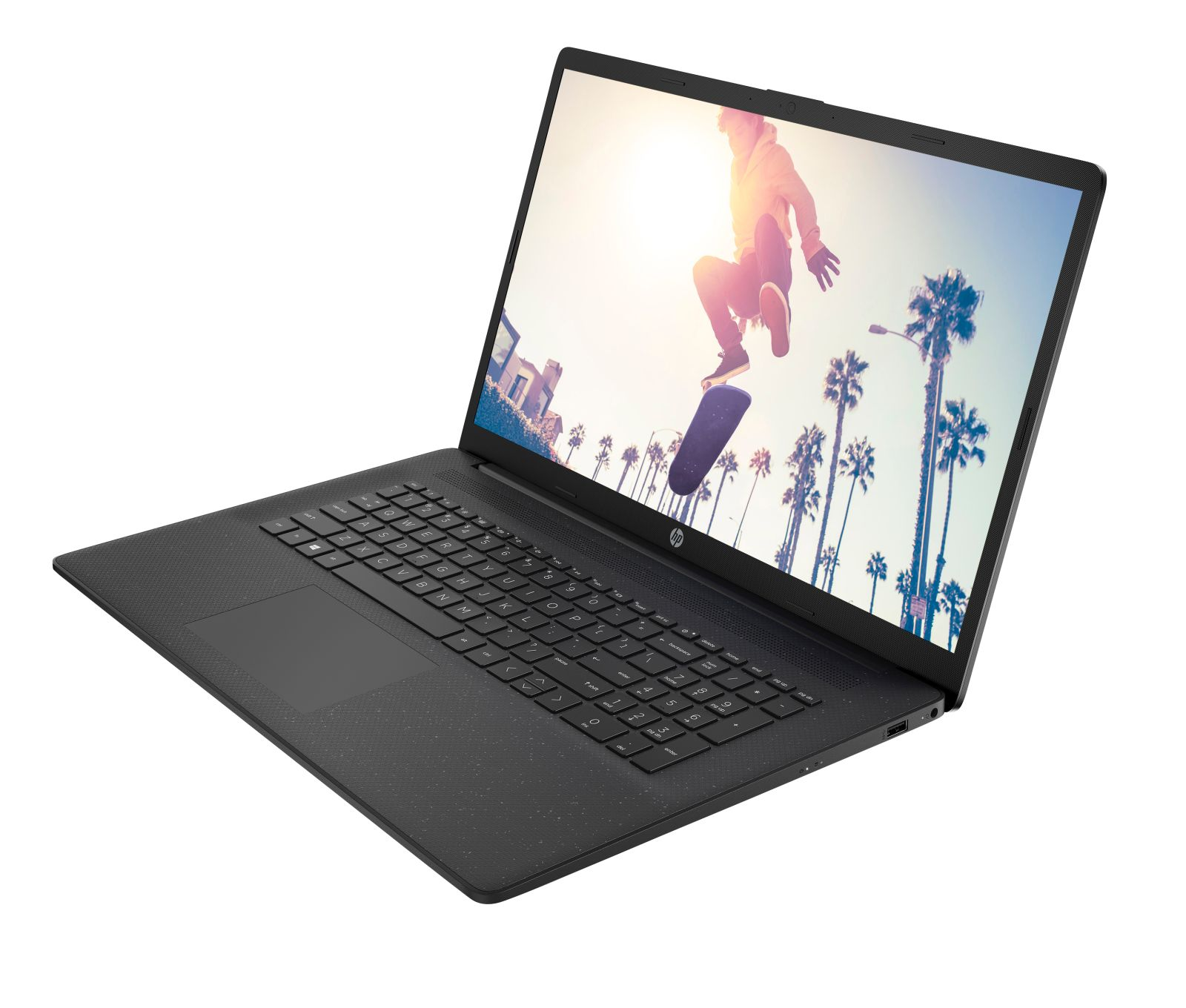 Czarny laptop HP jest otwarty, wyświetla deskorolkarza w powietrzu na tle palm i jasnego słońca.