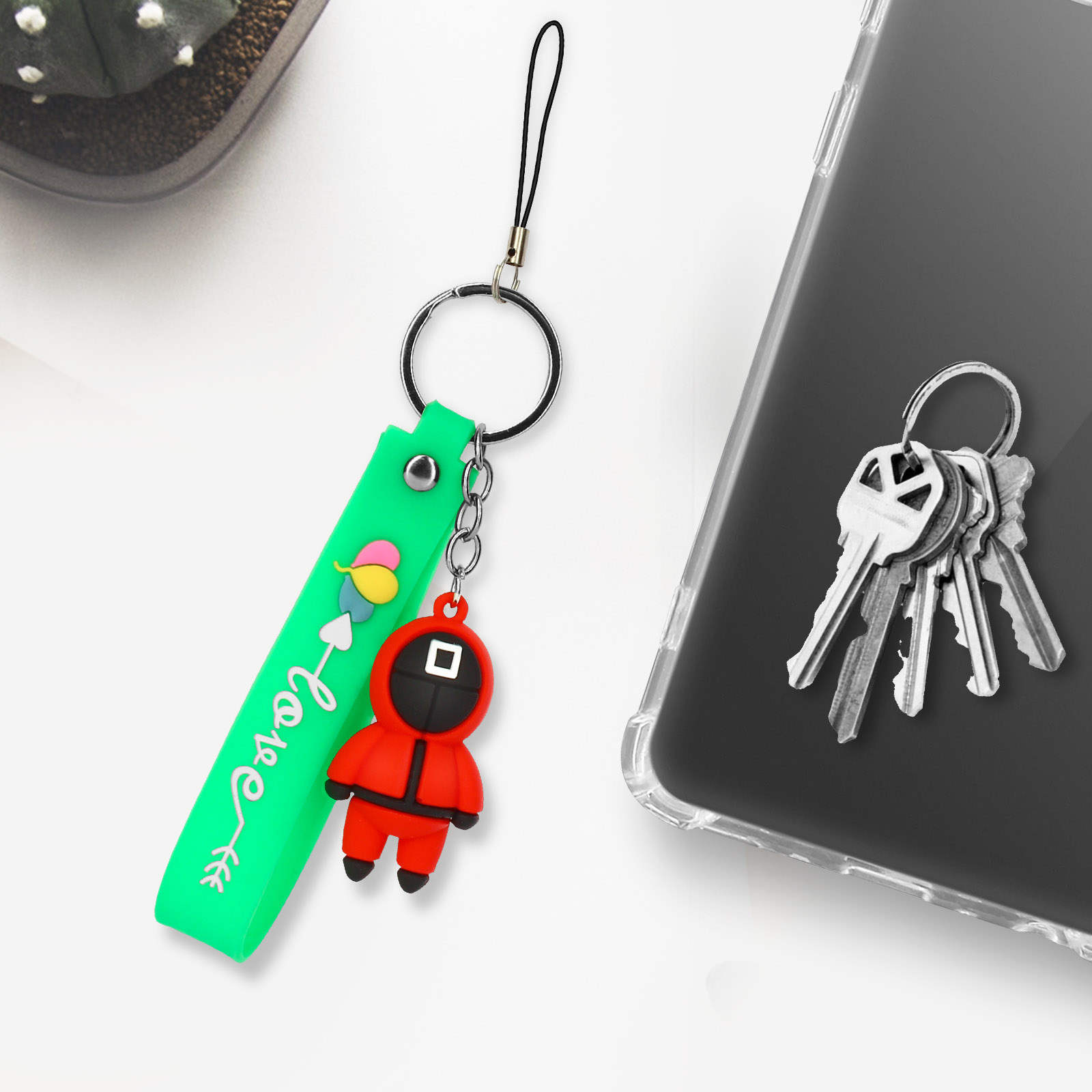 Un portachiavi verde con un personaggio di Squid Game e chiavi.