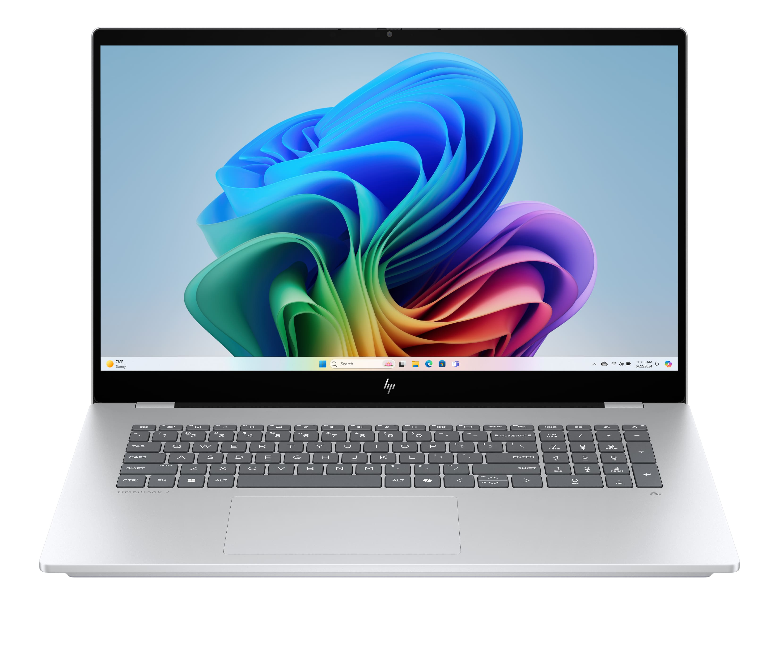Srebrny laptop z kolorową tapetą i klawiaturą.