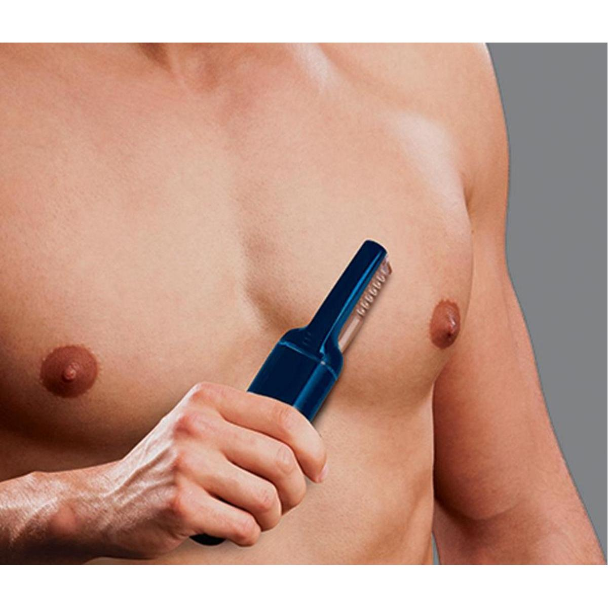A hand holds a dark blue electric trimmer near a man's chest.