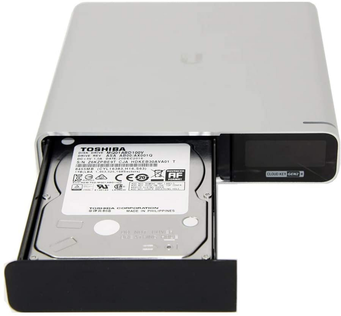 Un hard disk esterno argentato con un vassoio Toshiba HDD estratto.