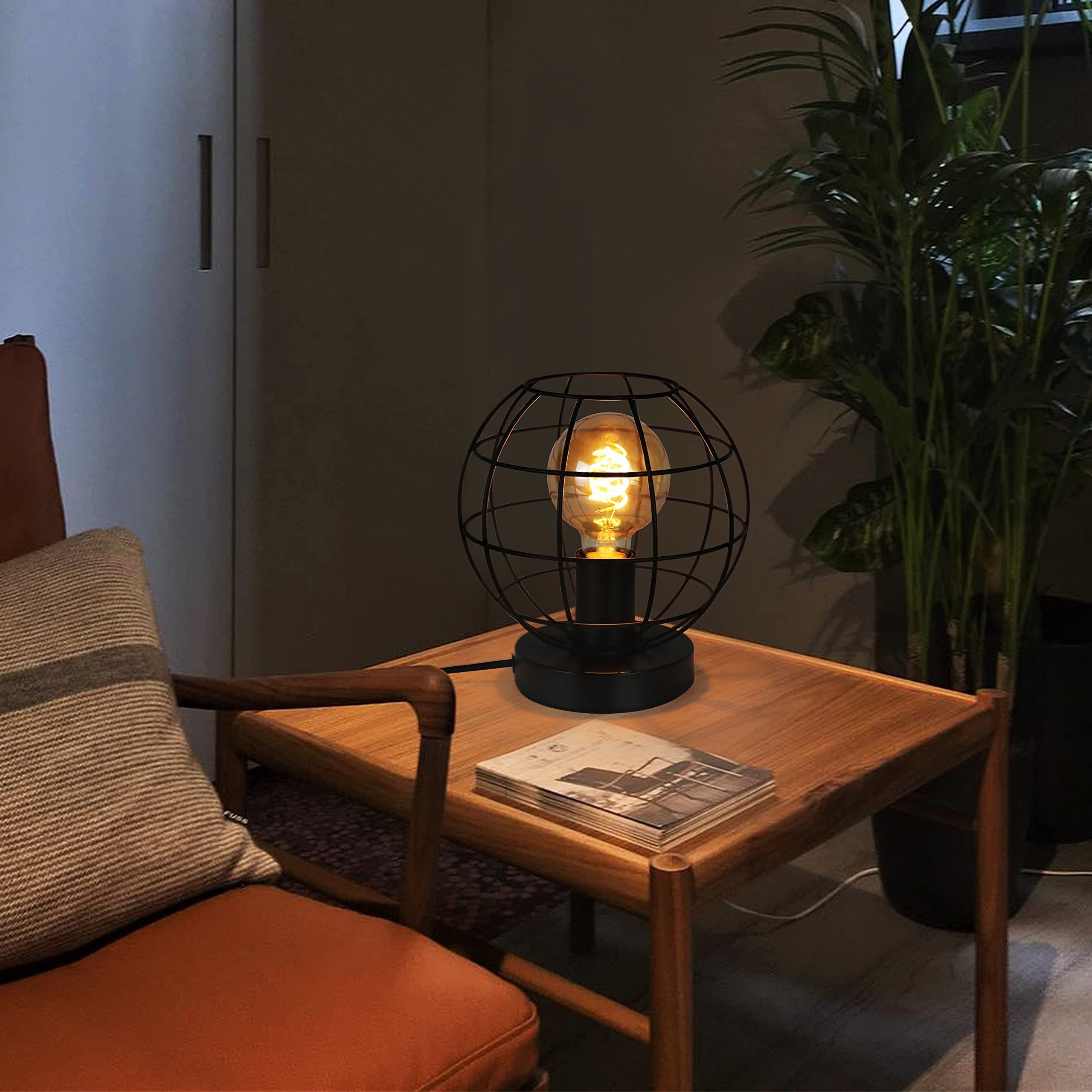 Lampada a gabbia nera con lampadina Edison su tavolino in legno.