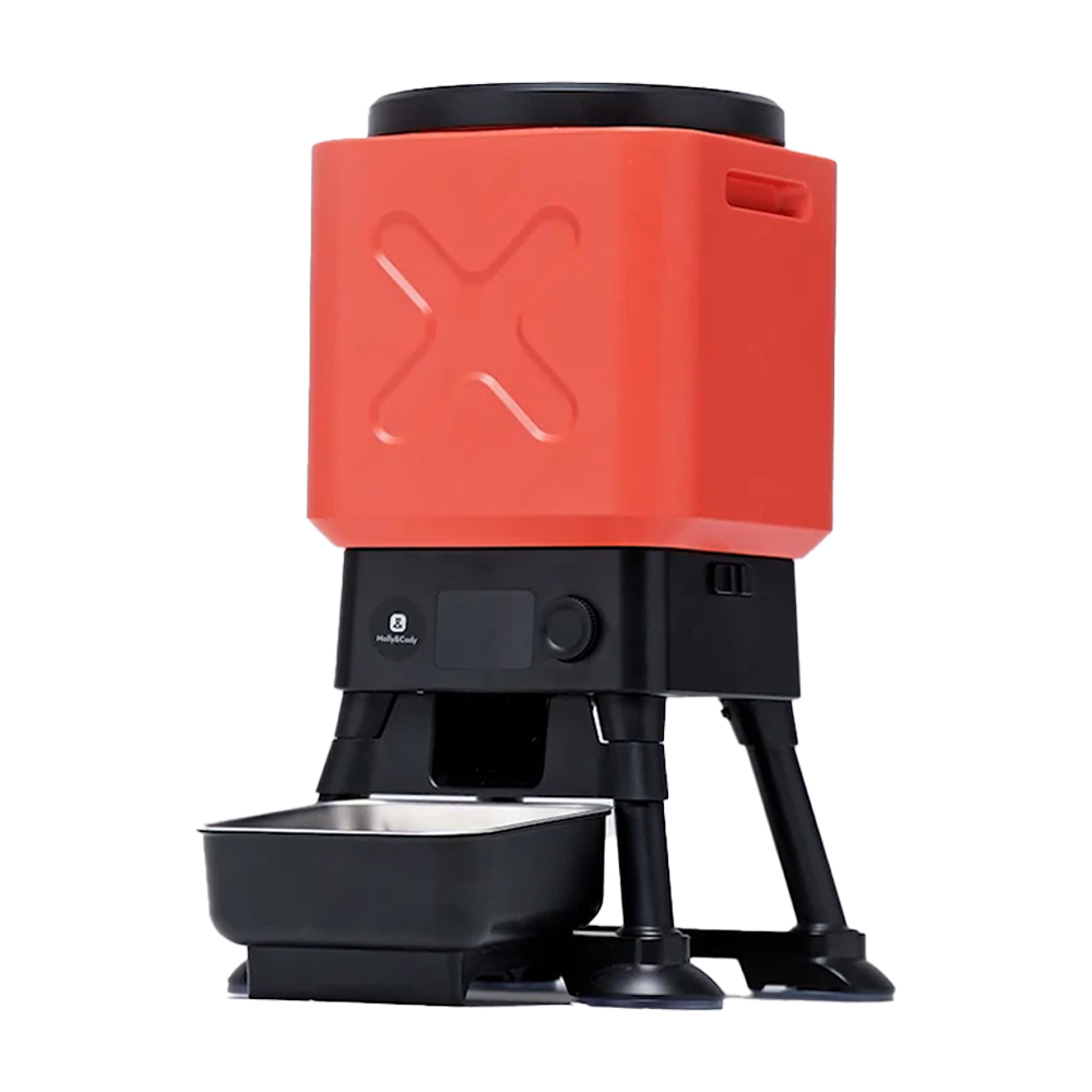 Un comedero automático para mascotas rojo y negro con un cuenco de metal.