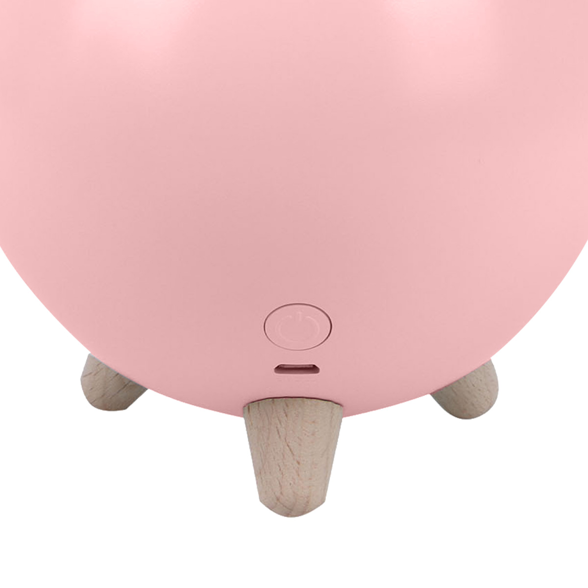 Nahaufnahme eines rosa Objekts mit drei Holzbeinen, einem Knopf und einem USB-Anschluss.