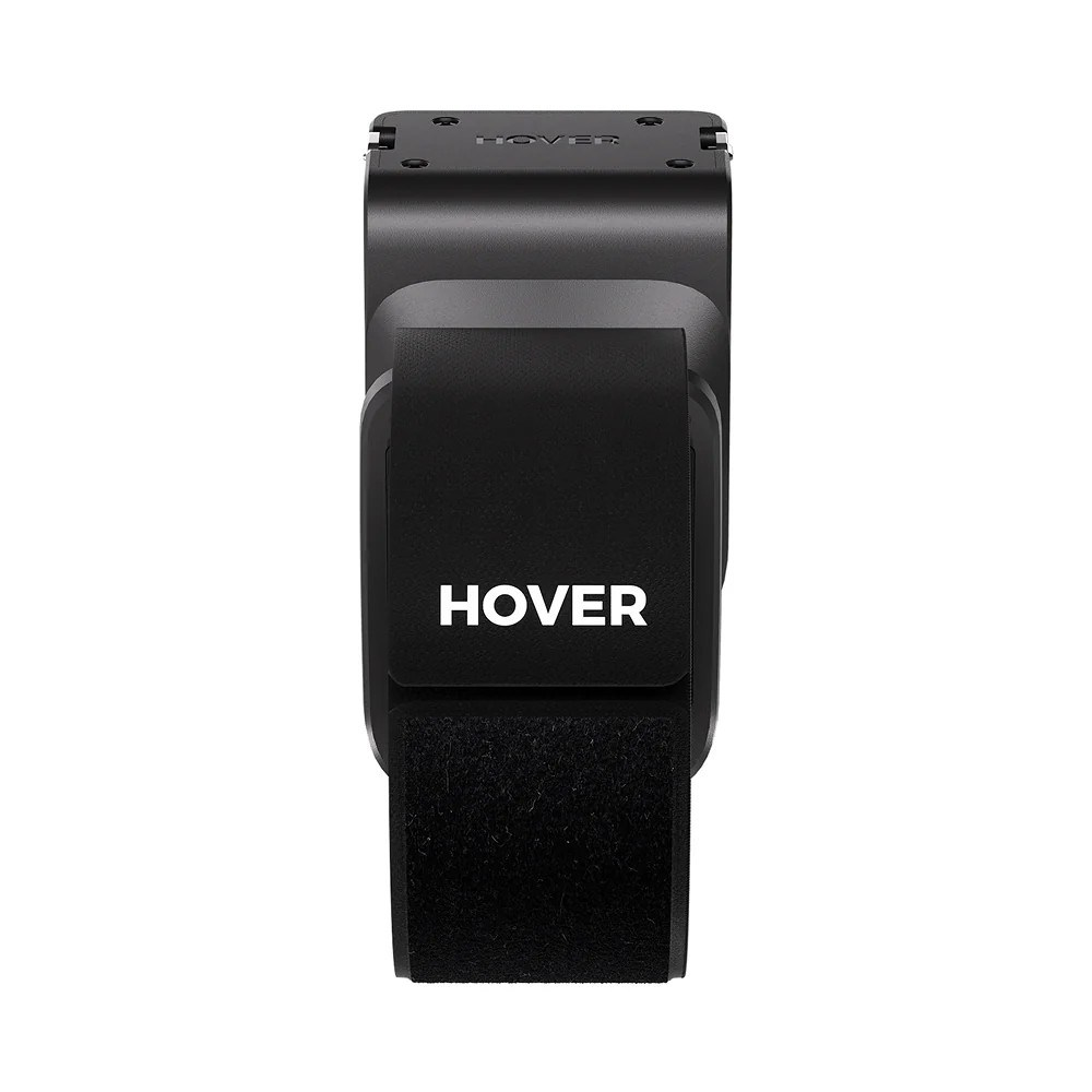Dispositivo nero marca Hover con cinturino in velcro, visto frontalmente su sfondo bianco.