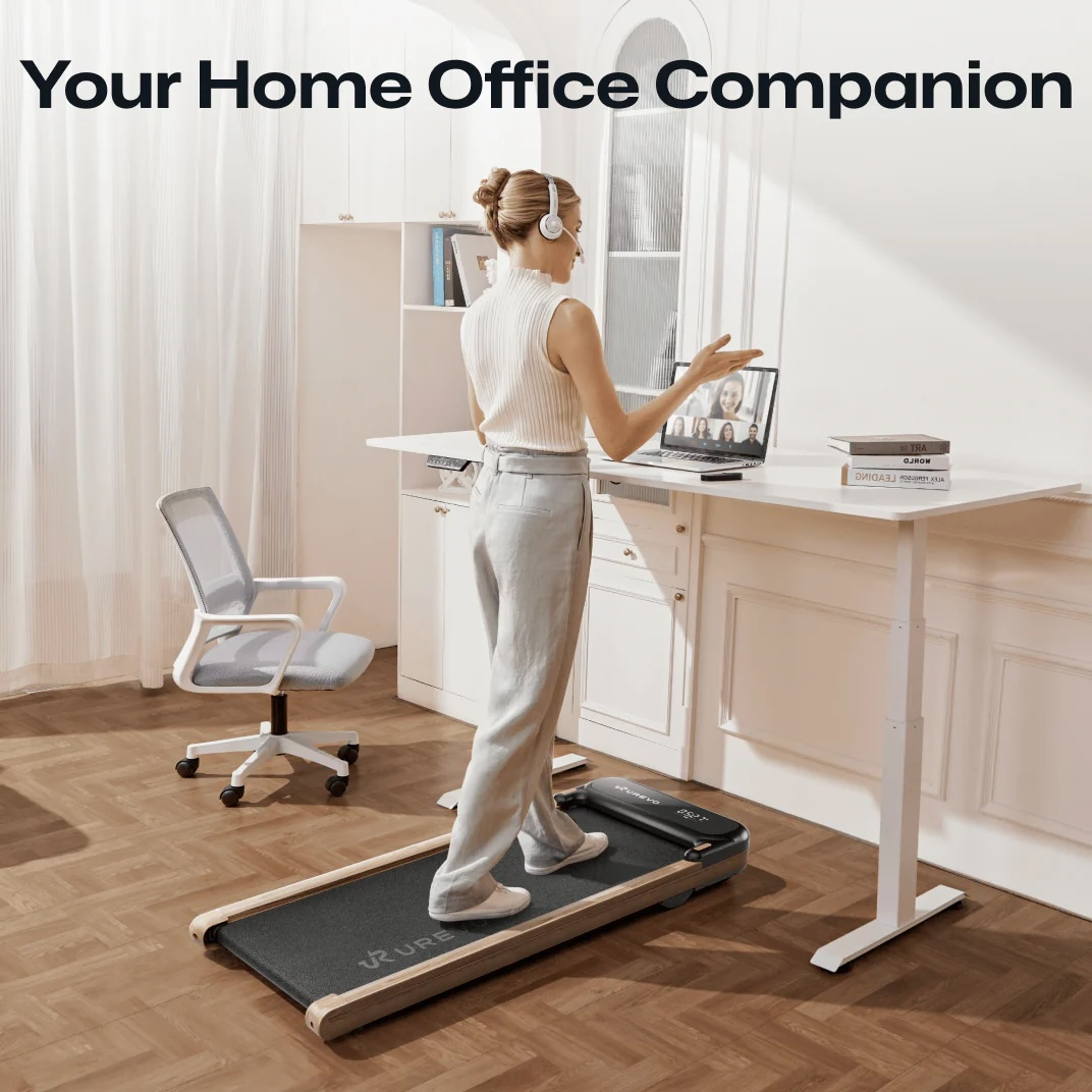 Kobieta idzie na bieżni przy biurku stojącym podczas wideokonferencji.